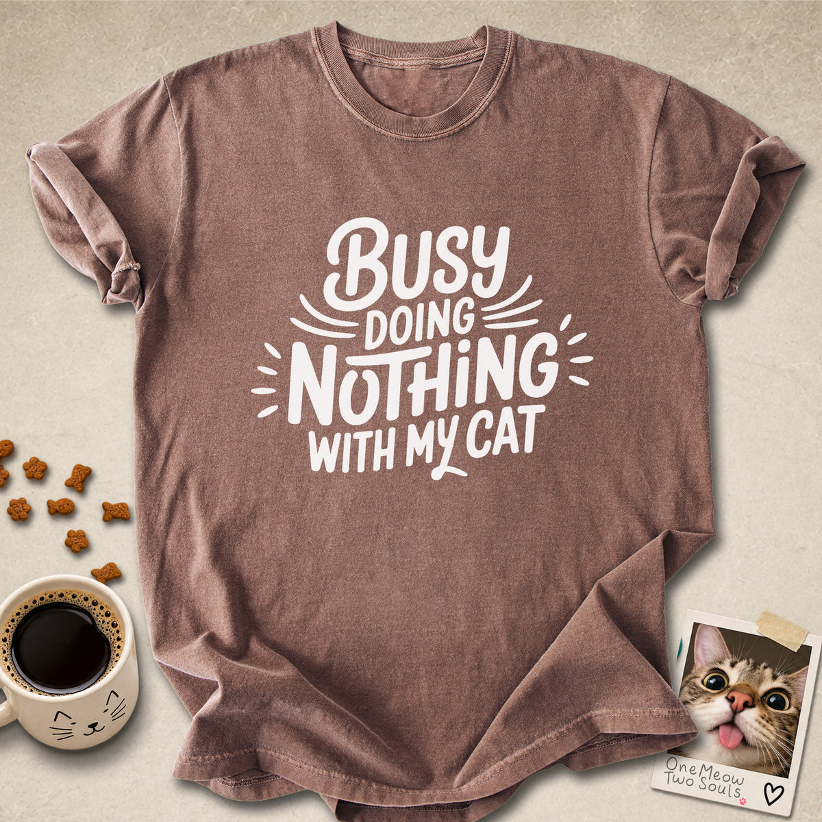 Espresso colored Comfort Colors 1717 cotton T-shirt, featuring a "Busy doing nothing with my cat" funny cat design illustration. One Meow Two Souls brand.