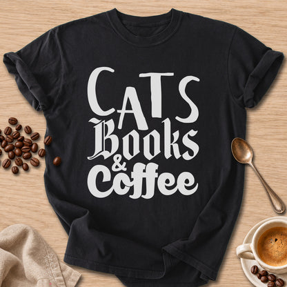 Black colored Comfort Colors 1717 cotton T-shirt, featuring a "Cats, Books & Coffee" funny cat design illustration. One Meow Two Souls brand.