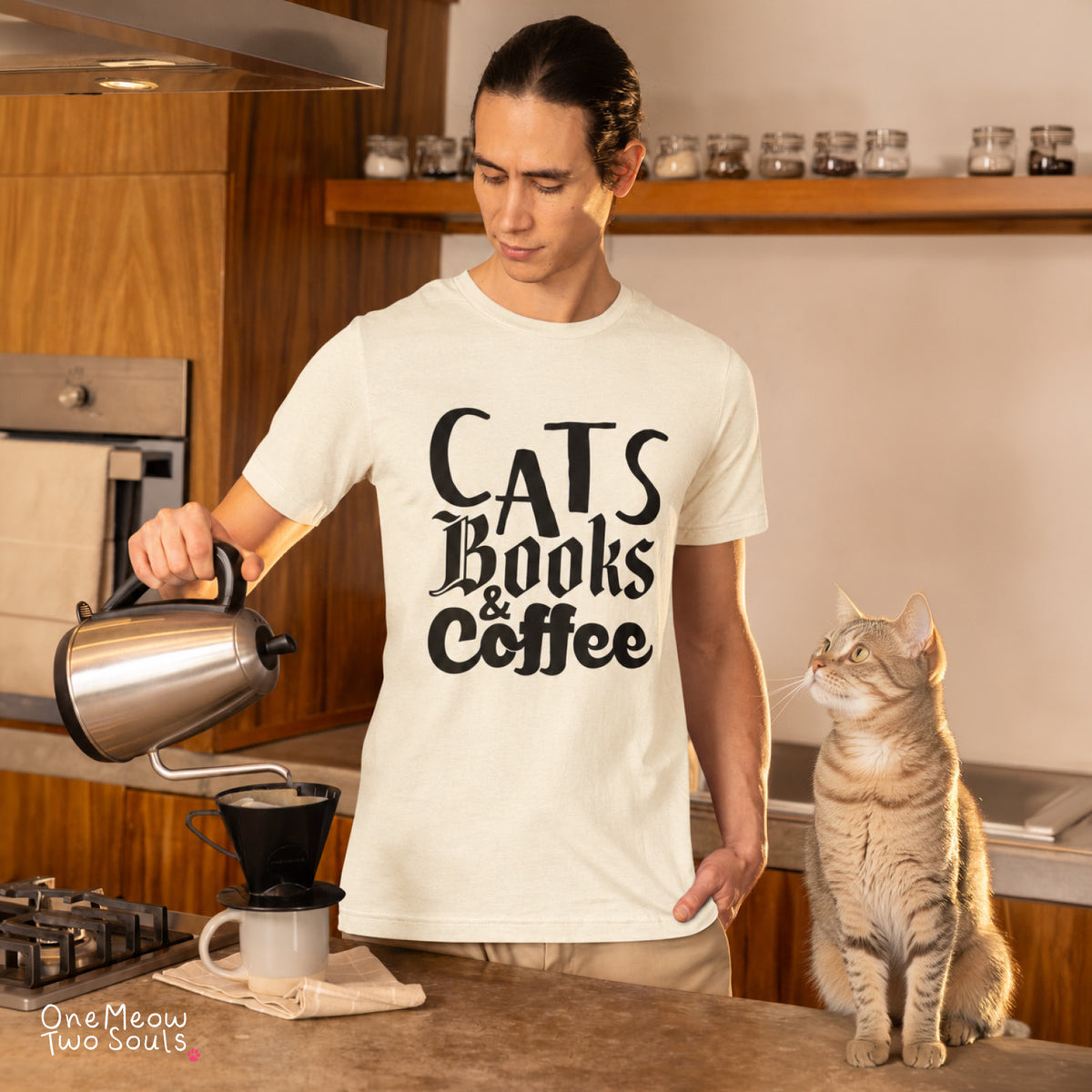 Ivory colored Comfort Colors 1717 cotton T-shirt, featuring a "Cats, Books & Coffee" funny cat design illustration. One Meow Two Souls brand.