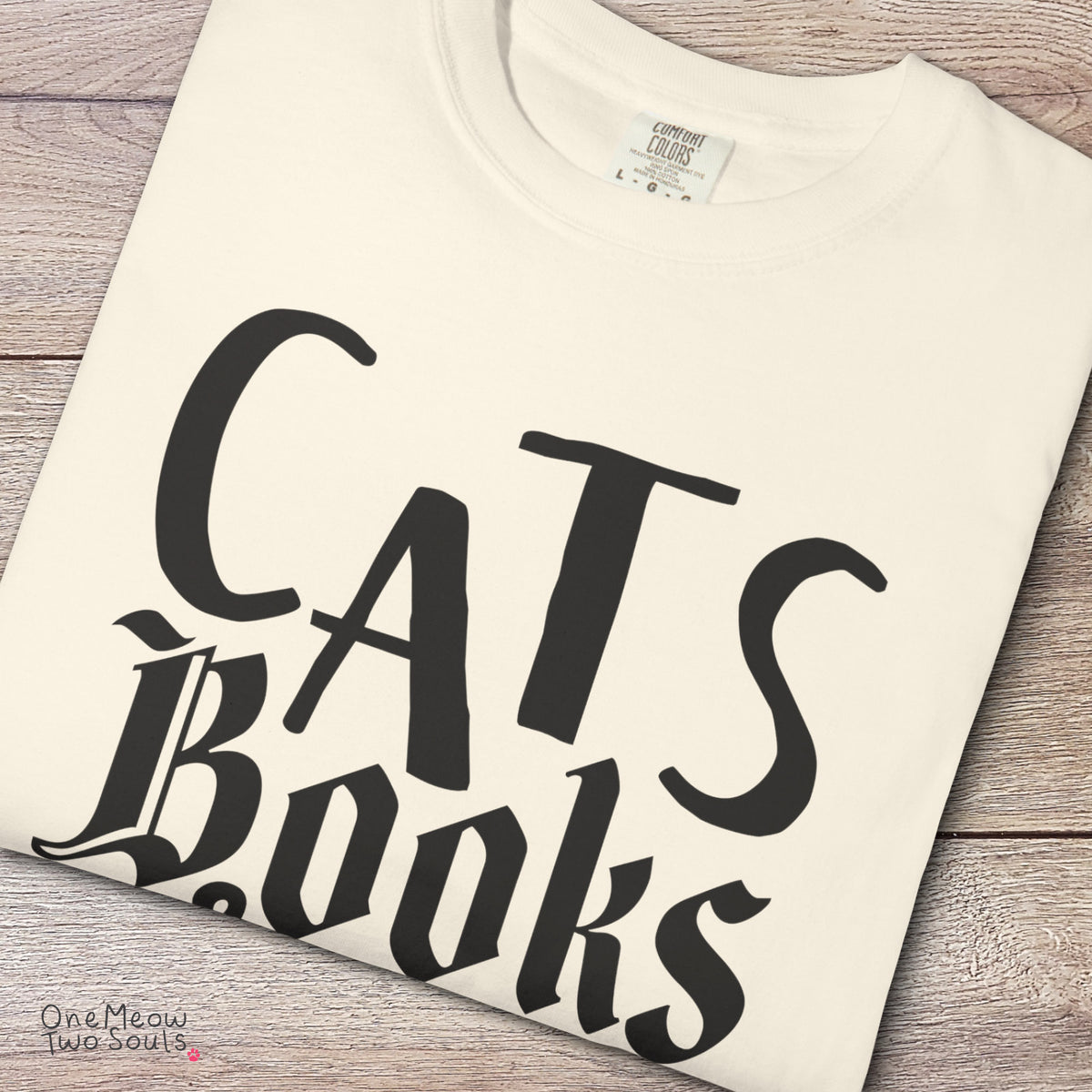 Ivory colored Comfort Colors 1717 cotton T-shirt, featuring a "Cats, Books & Coffee" funny cat design illustration. One Meow Two Souls brand.