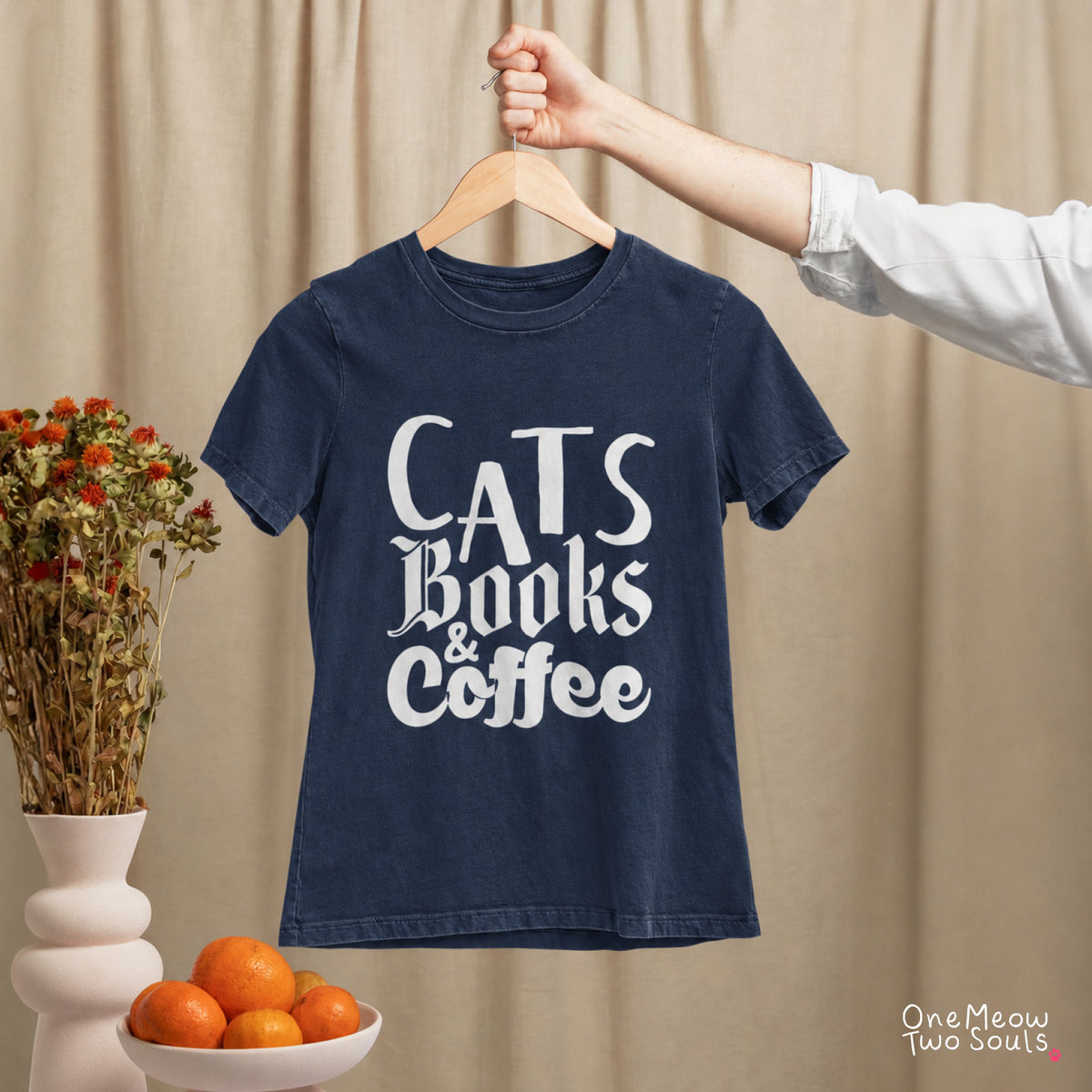 Navy colored Comfort Colors 1717 cotton T-shirt, featuring a "Cats, Books & Coffee" funny cat design illustration. One Meow Two Souls brand.