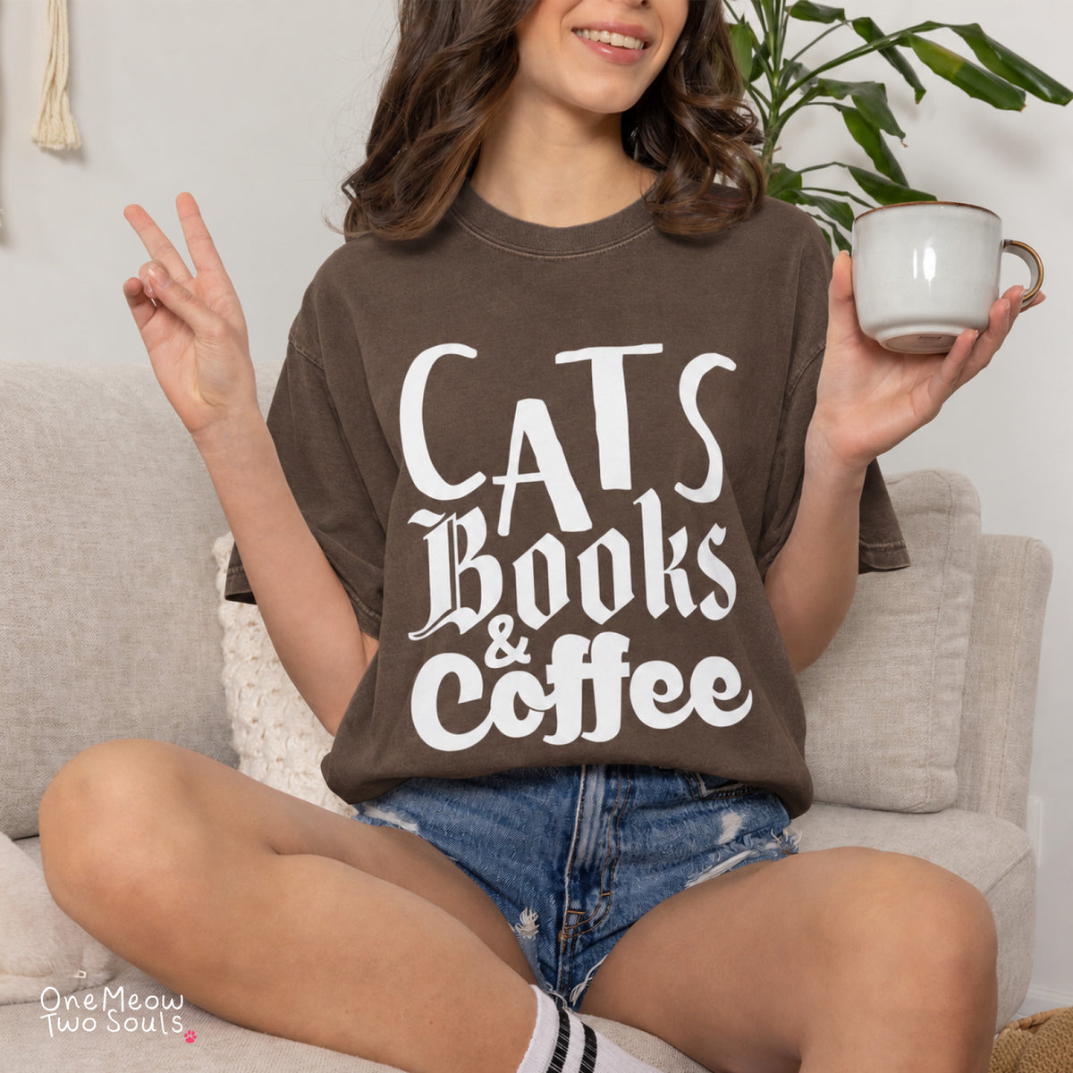 Espresso colored Comfort Colors 1717 cotton T-shirt, featuring a "Cats, Books & Coffee" funny cat design illustration. One Meow Two Souls brand.