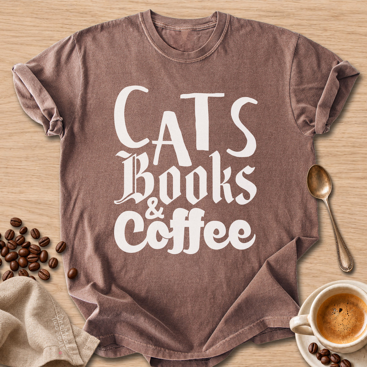Espresso colored Comfort Colors 1717 cotton T-shirt, featuring a "Cats, Books & Coffee" funny cat design illustration. One Meow Two Souls brand.