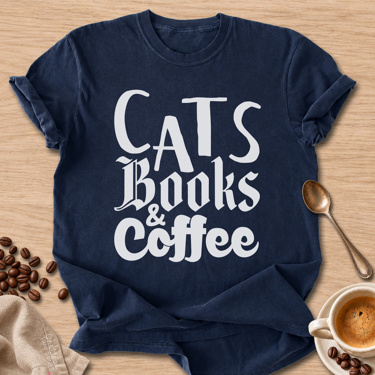 Navy colored Comfort Colors 1717 cotton T-shirt, featuring a "Cats, Books & Coffee" funny cat design illustration. One Meow Two Souls brand.