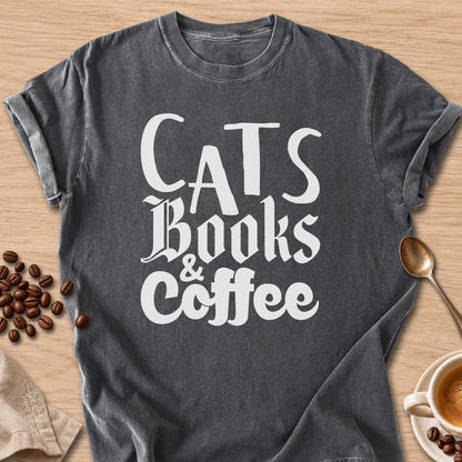 Pepper colored Comfort Colors 1717 cotton T-shirt, featuring a "Cats, Books & Coffee" funny cat design illustration. One Meow Two Souls brand.