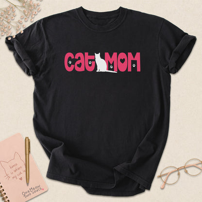 Black colored Comfort Colors 1717 cotton T-shirt, featuring a "Cat Mom" cute cat design illustration. One Meow Two Souls brand.