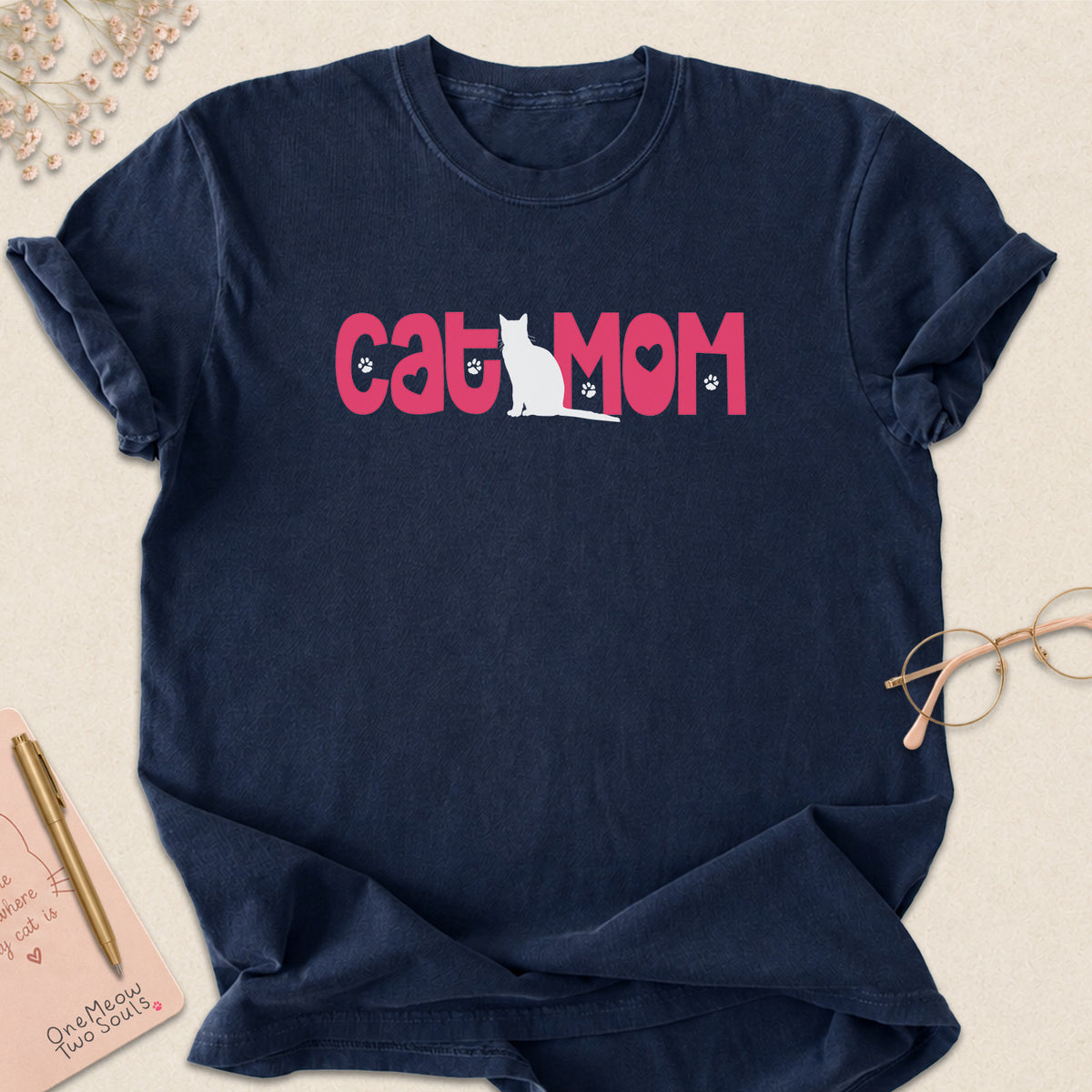 Navy colored Comfort Colors 1717 cotton T-shirt, featuring a "Cat Mom" cute cat design illustration. One Meow Two Souls brand.