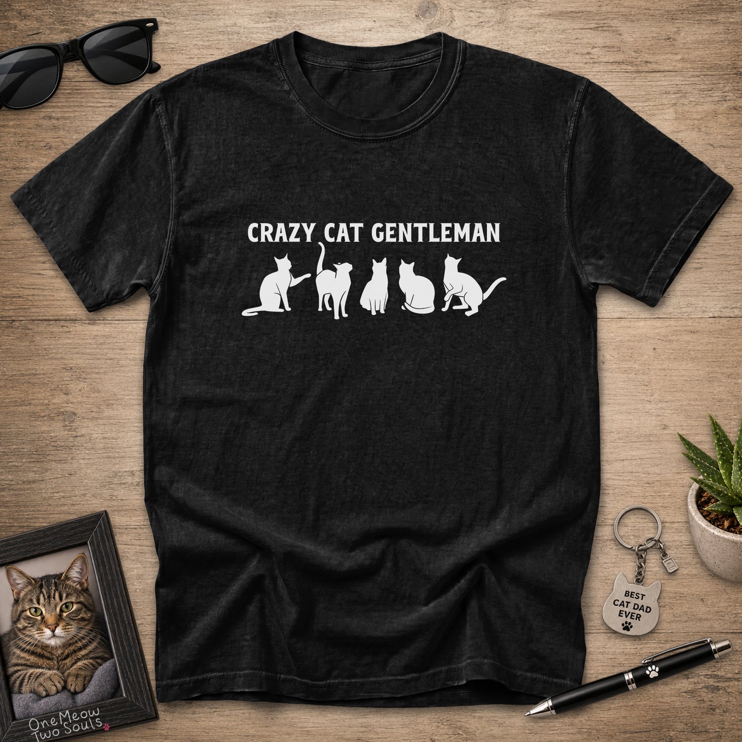 Black Comfort Colors 1717 Crazy Cat Gentleman graphic T-shirt with white cat silhouettes.