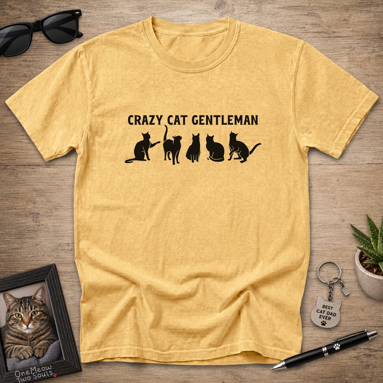 Mustard Comfort Colors 1717 Crazy Cat Gentleman graphic T-shirt with white cat silhouettes.