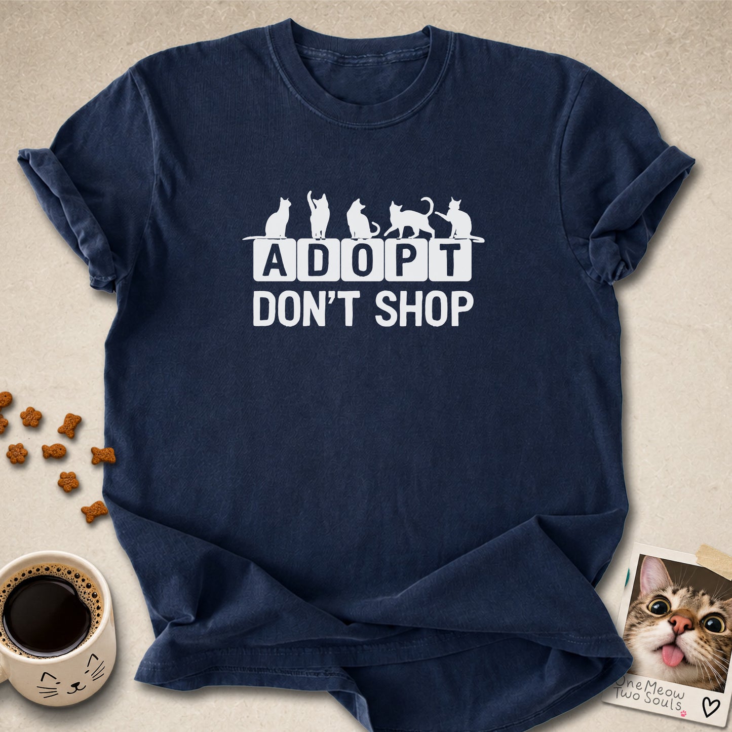 Navy colored Comfort Colors 1717 cotton T-shirt, featuring a "Adopt Don't Shop" funny cat design illustration. One Meow Two Souls brand.