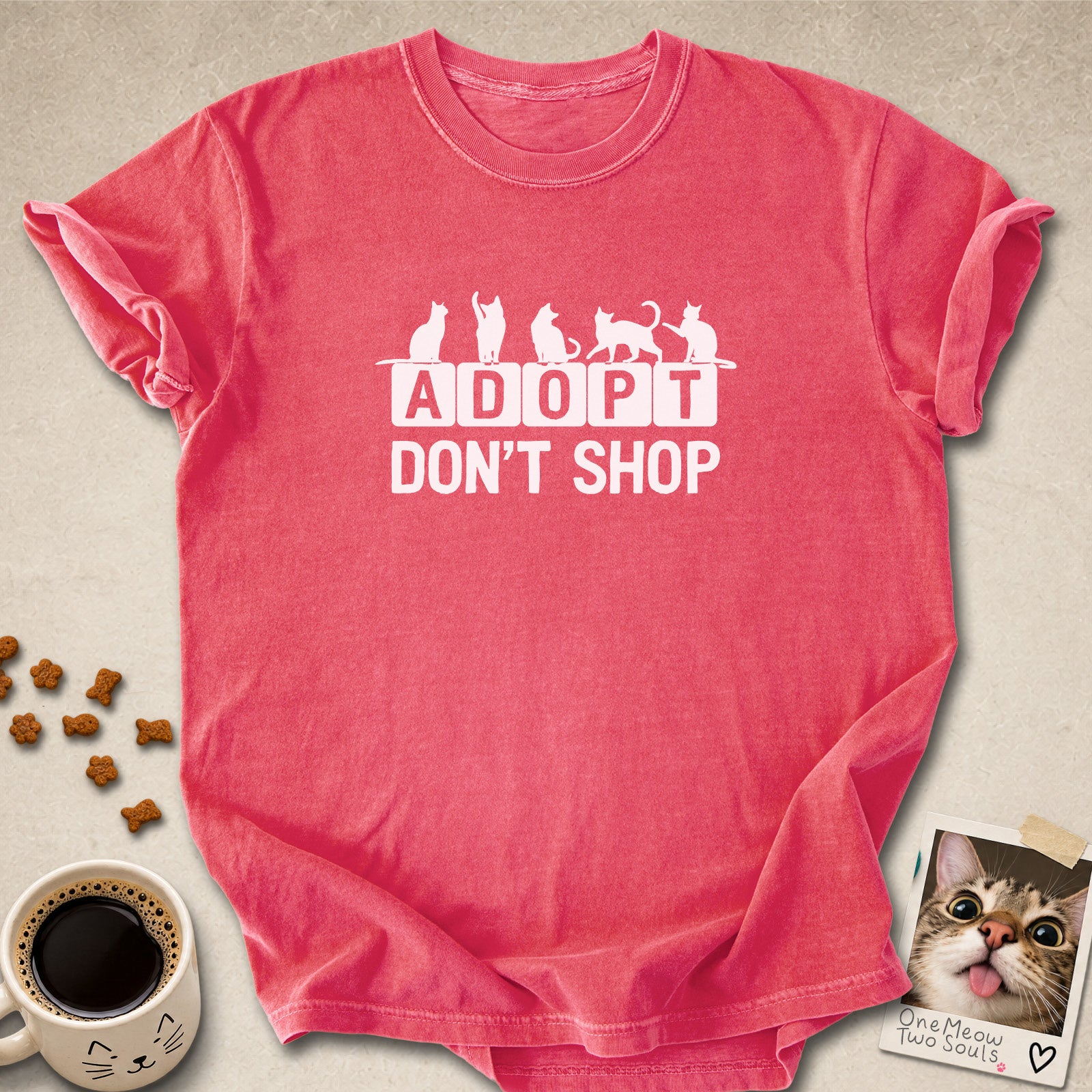 Watermelon colored Comfort Colors 1717 cotton T-shirt, featuring a "Adopt Don't Shop" funny cat design illustration. One Meow Two Souls brand.