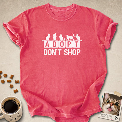 Watermelon colored Comfort Colors 1717 cotton T-shirt, featuring a "Adopt Don't Shop" funny cat design illustration. One Meow Two Souls brand.