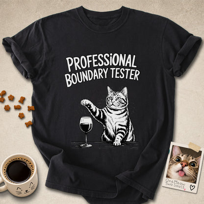 Black colored Comfort Colors 1717 cotton T-shirt, featuring a "Professional Boundry Tester" funny cat design illustration. One Meow Two Souls brand.