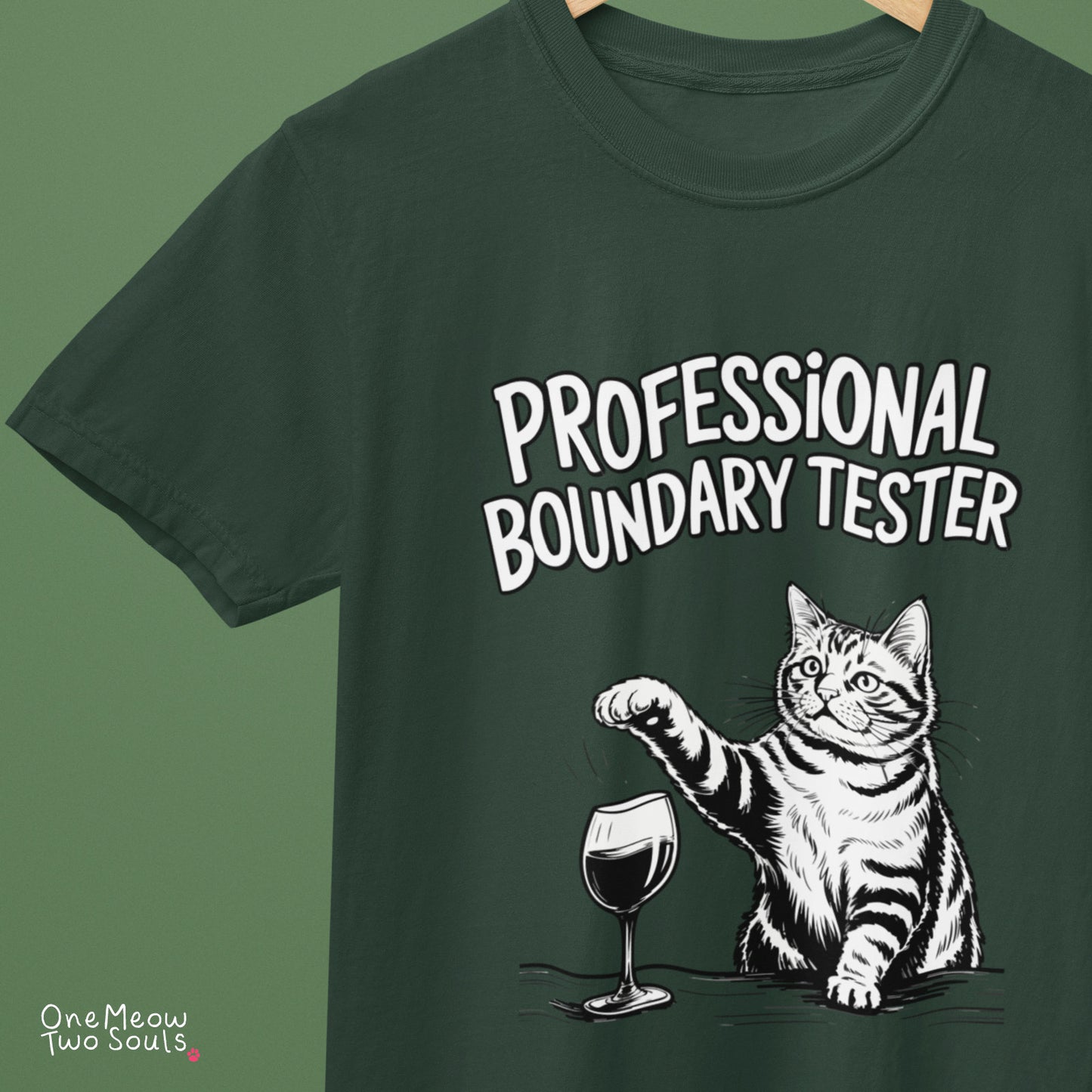 Moss colored Comfort Colors 1717 cotton T-shirt, featuring a "Professional Boundry Tester" funny cat design illustration. One Meow Two Souls brand.