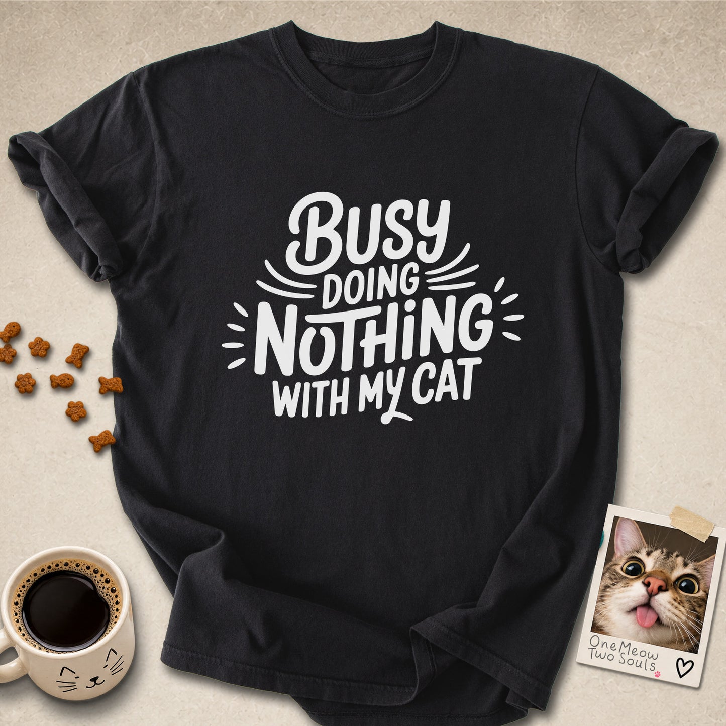 Black colored Comfort Colors 1717 cotton T-shirt, featuring a "Busy doing nothing with my cat" funny cat design illustration. One Meow Two Souls brand.