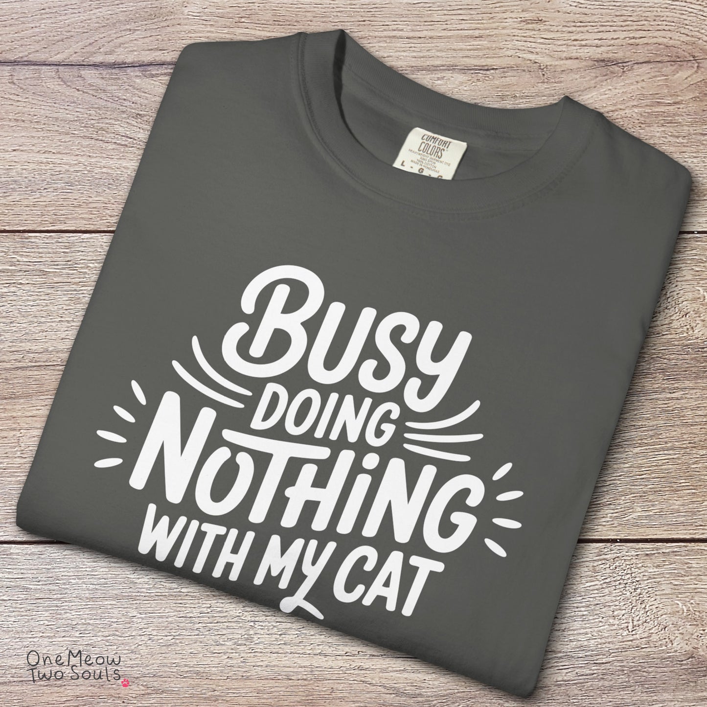 Pepper colored Comfort Colors 1717 cotton T-shirt, featuring a "Busy doing nothing with my cat" funny cat design illustration. One Meow Two Souls brand.