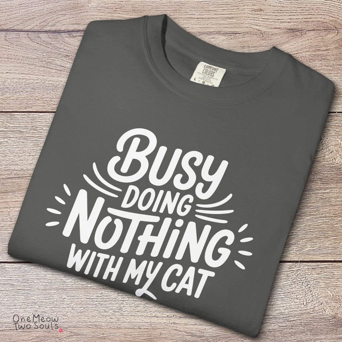 Pepper colored Comfort Colors 1717 cotton T-shirt, featuring a "Busy doing nothing with my cat" funny cat design illustration. One Meow Two Souls brand.