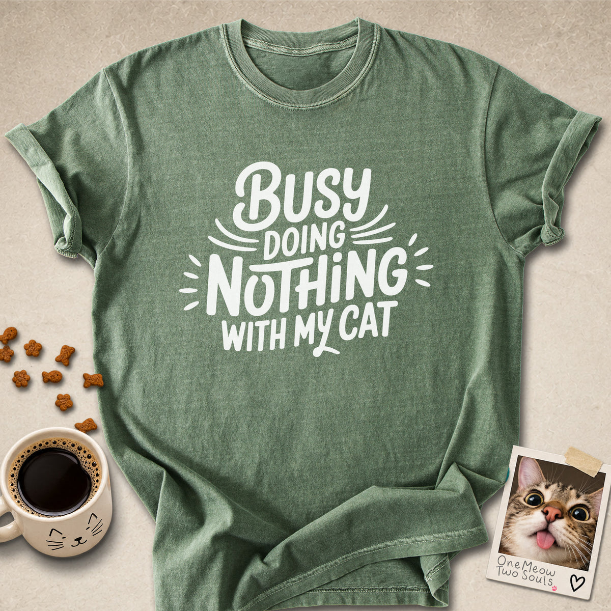 Moss colored Comfort Colors 1717 cotton T-shirt, featuring a "Busy doing nothing with my cat" funny cat design illustration. One Meow Two Souls brand.