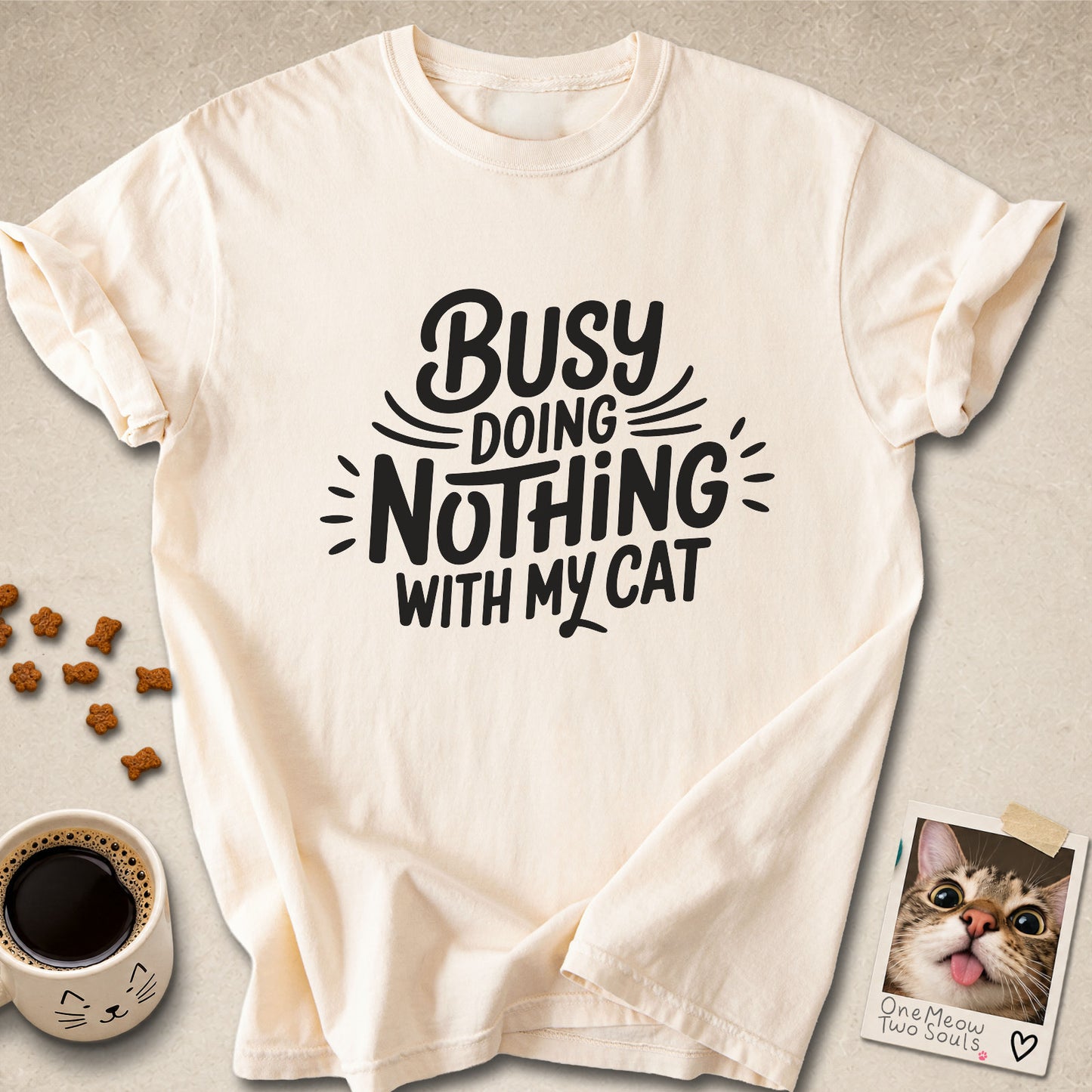 Ivory colored Comfort Colors 1717 cotton T-shirt, featuring a "Busy doing nothing with my cat" funny cat design illustration. One Meow Two Souls brand.