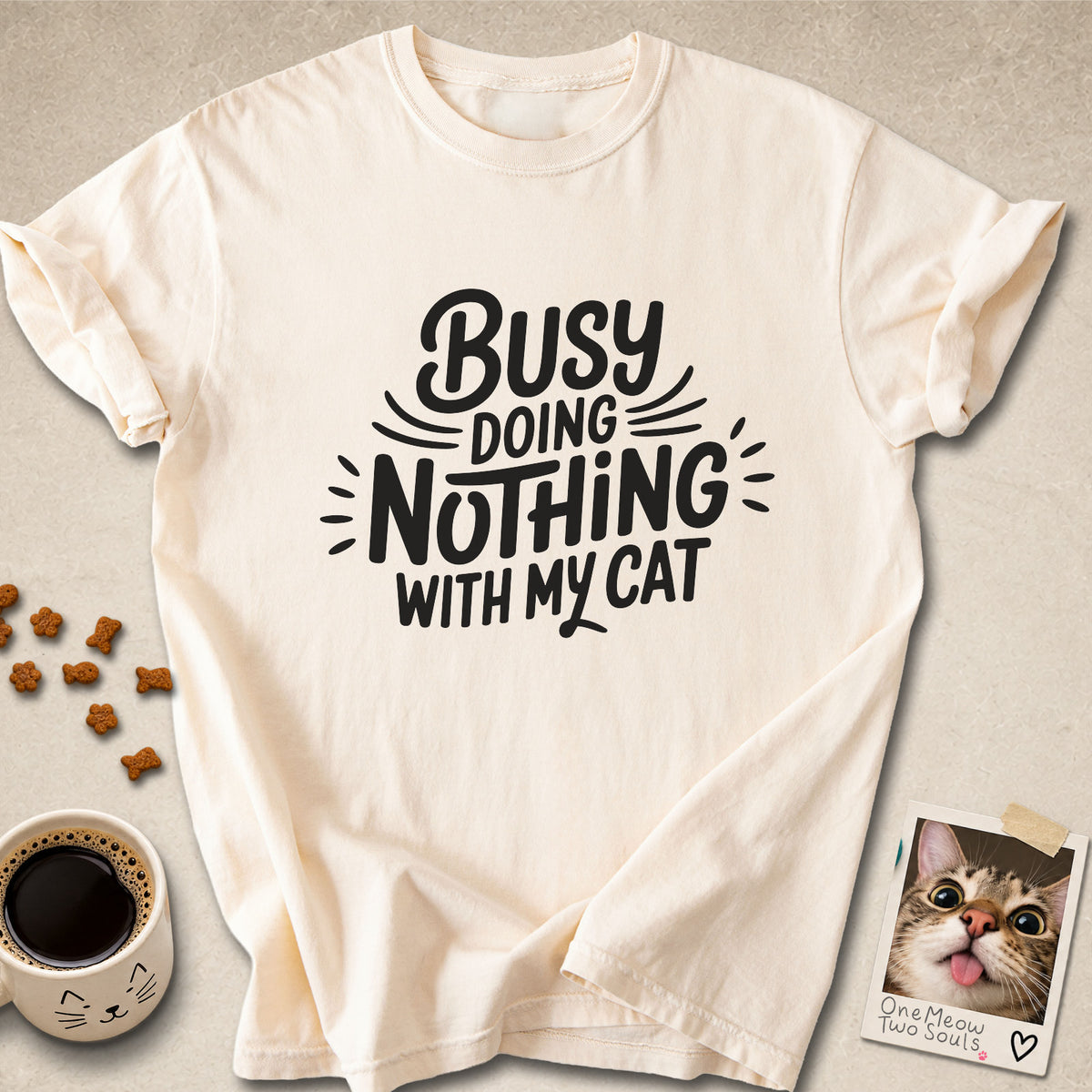 Ivory colored Comfort Colors 1717 cotton T-shirt, featuring a "Busy doing nothing with my cat" funny cat design illustration. One Meow Two Souls brand.