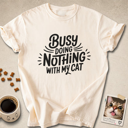 Ivory colored Comfort Colors 1717 cotton T-shirt, featuring a "Busy doing nothing with my cat" funny cat design illustration. One Meow Two Souls brand.