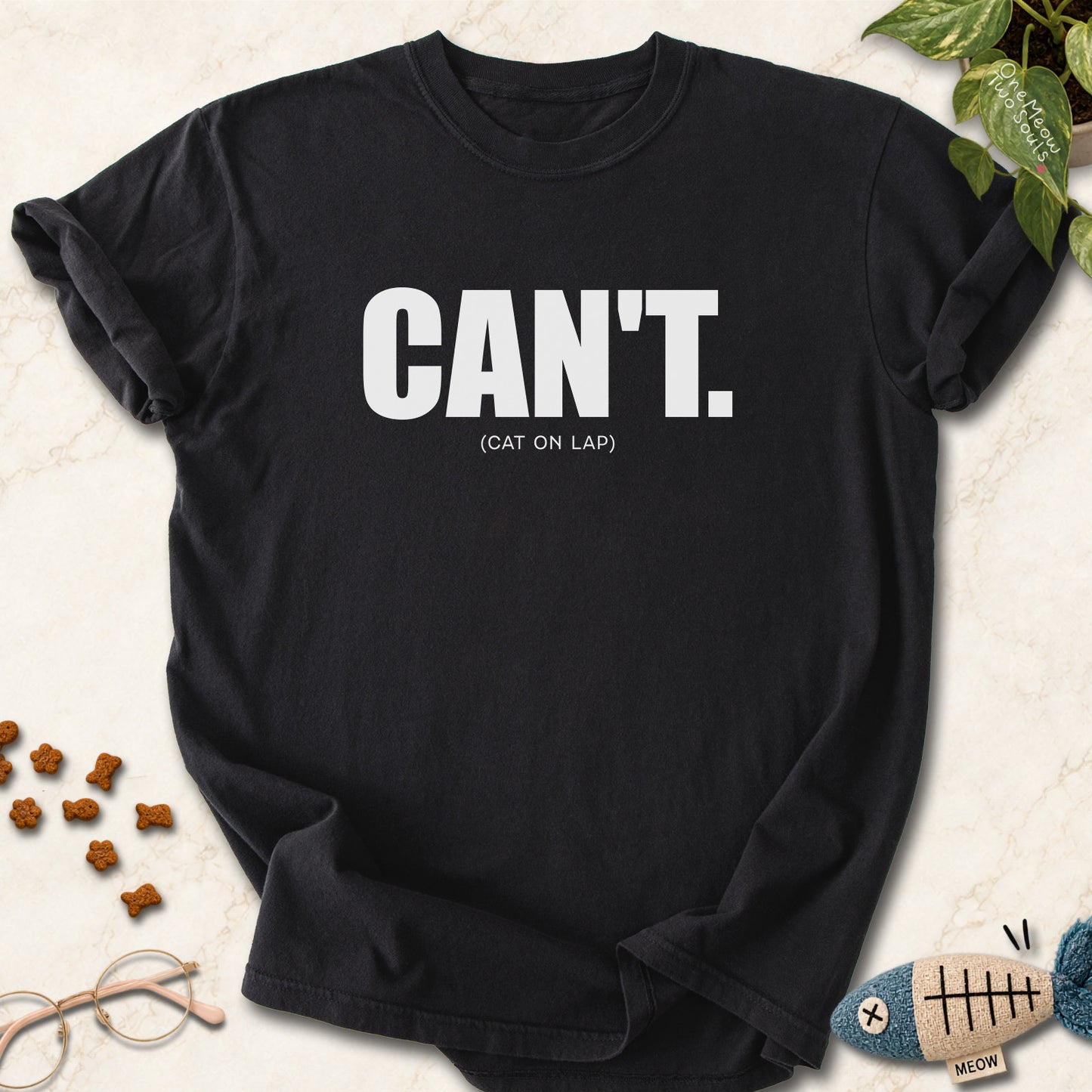 Black colored Comfort Colors 1717 cotton T-shirt, featuring a "Can't. (cat on lap)" funny cat design illustration. One Meow Two Souls brand.