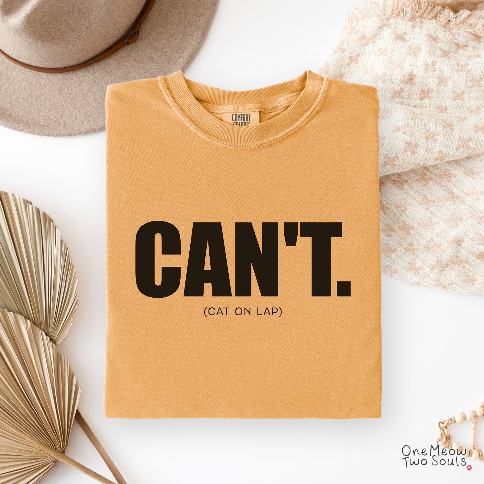 Mustard colored Comfort Colors 1717 cotton T-shirt, featuring a "Can't. (cat on lap)" funny cat design illustration. One Meow Two Souls brand.