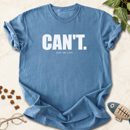 Blue jean colored Comfort Colors 1717 cotton T-shirt, featuring a "Can't. (cat on lap)" funny cat design illustration. One Meow Two Souls brand.