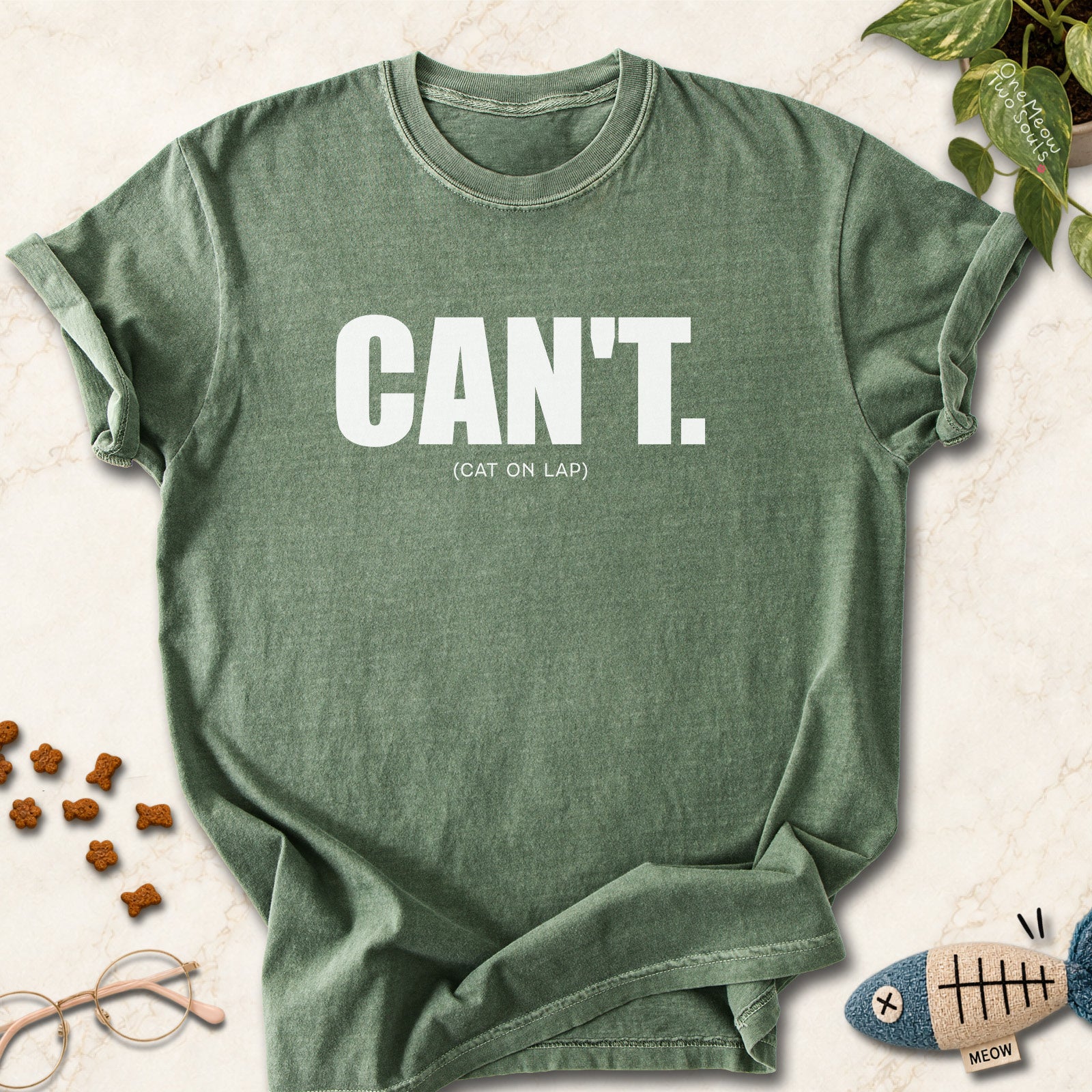 Moss colored Comfort Colors 1717 cotton T-shirt, featuring a "Can't. (cat on lap)" funny cat design illustration. One Meow Two Souls brand.