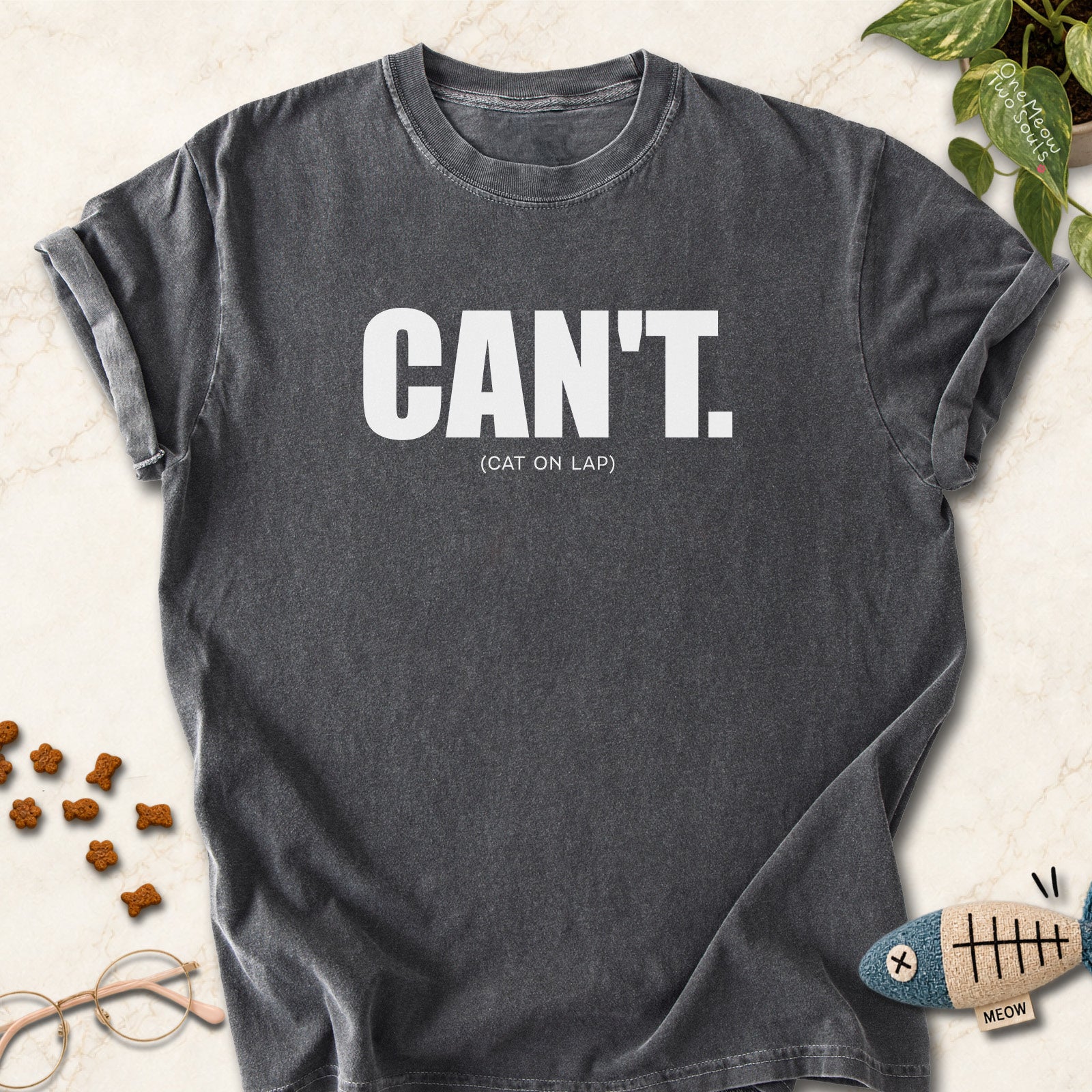 Pepper colored Comfort Colors 1717 cotton T-shirt, featuring a "Can't. (cat on lap)" funny cat design illustration. One Meow Two Souls brand.