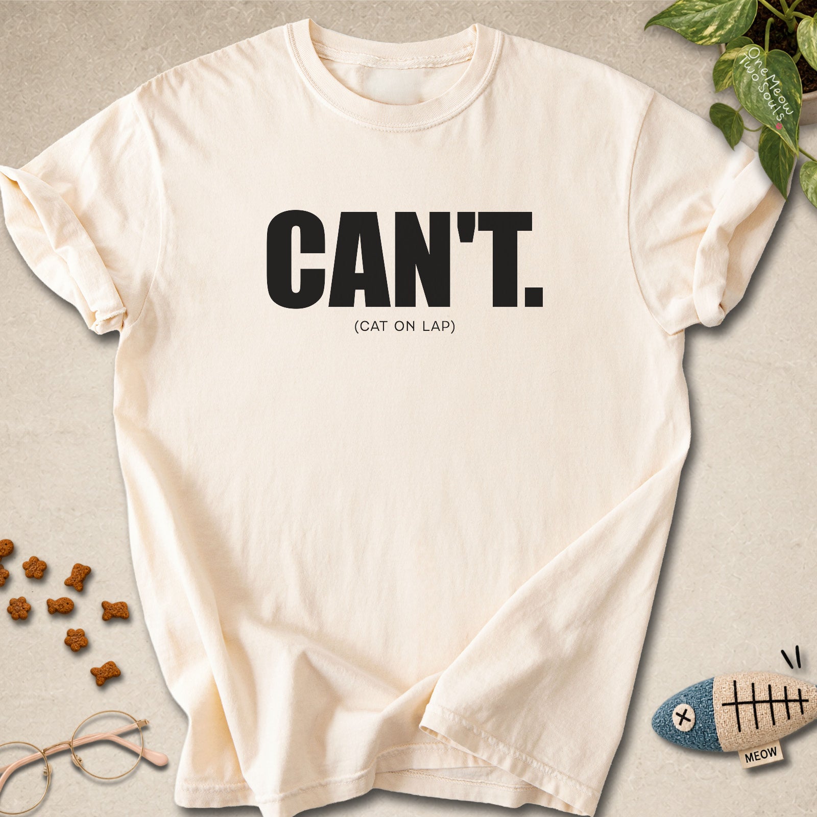 Ivory colored Comfort Colors 1717 cotton T-shirt, featuring a "Can't. (cat on lap)" funny cat design illustration. One Meow Two Souls brand.