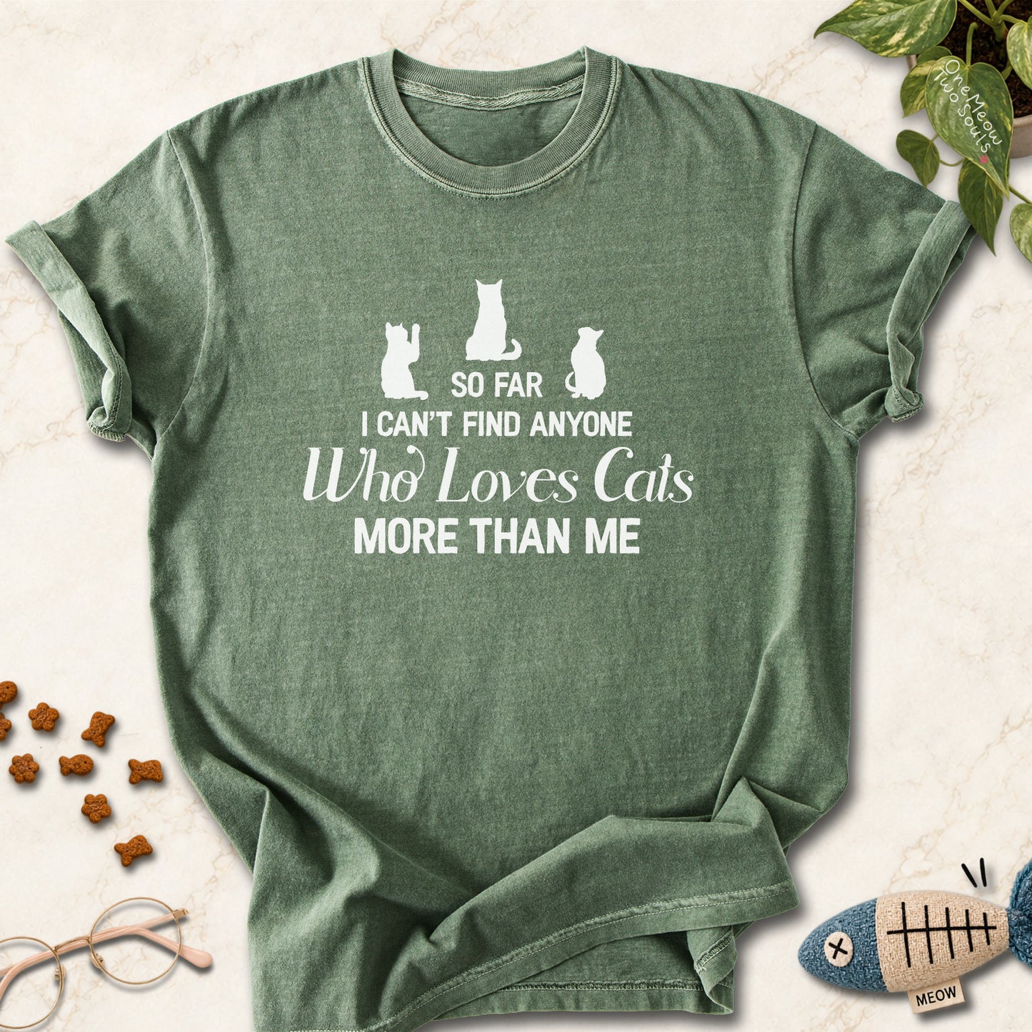 Moss colored Comfort Colors 1717 cotton T-shirt, featuring a "So I can't find anyone who loves cats more than me" funny cat design illustration. One Meow Two Souls brand.