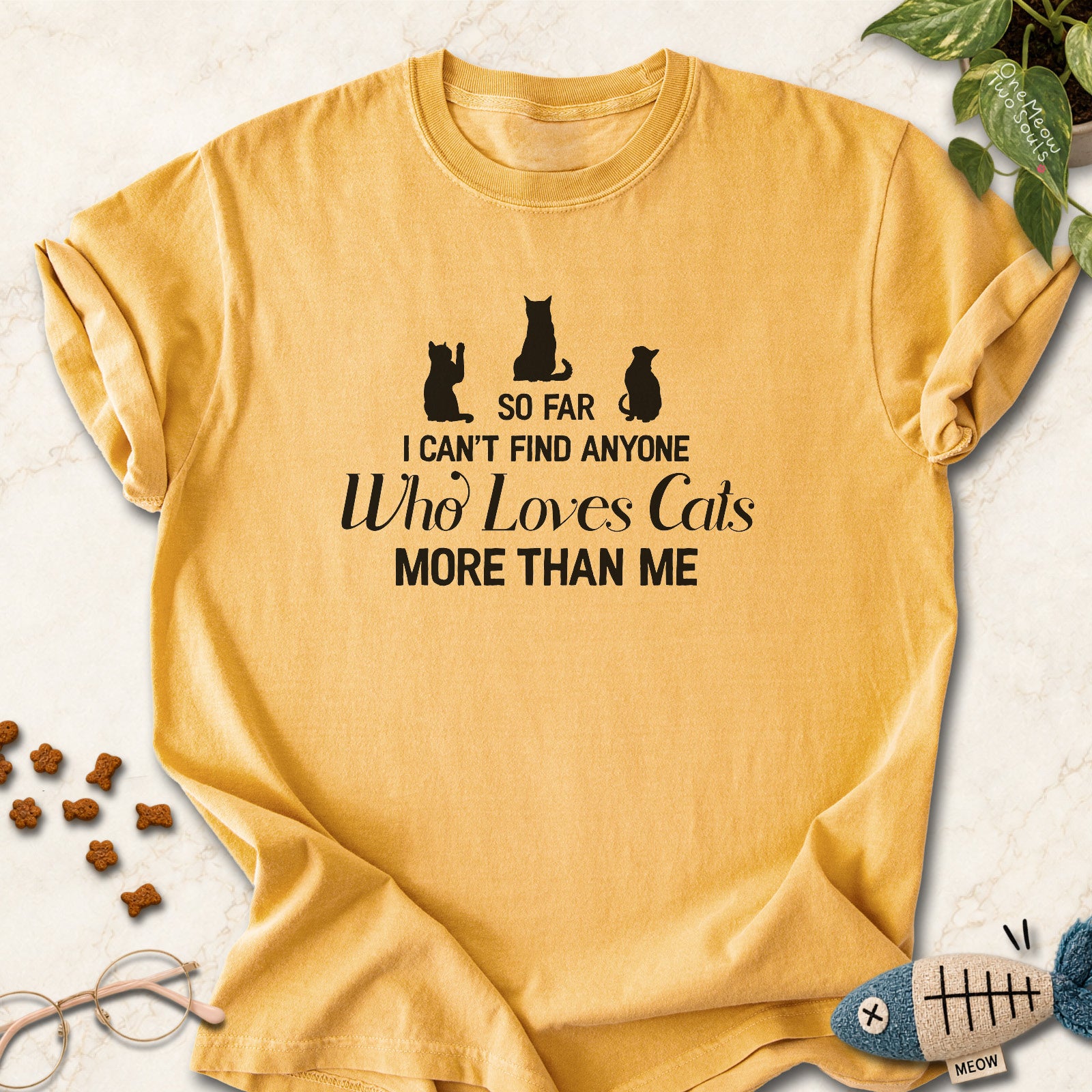 Mustard colored Comfort Colors 1717 cotton T-shirt, featuring a "So I can't find anyone who loves cats more than me" funny cat design illustration. One Meow Two Souls brand.