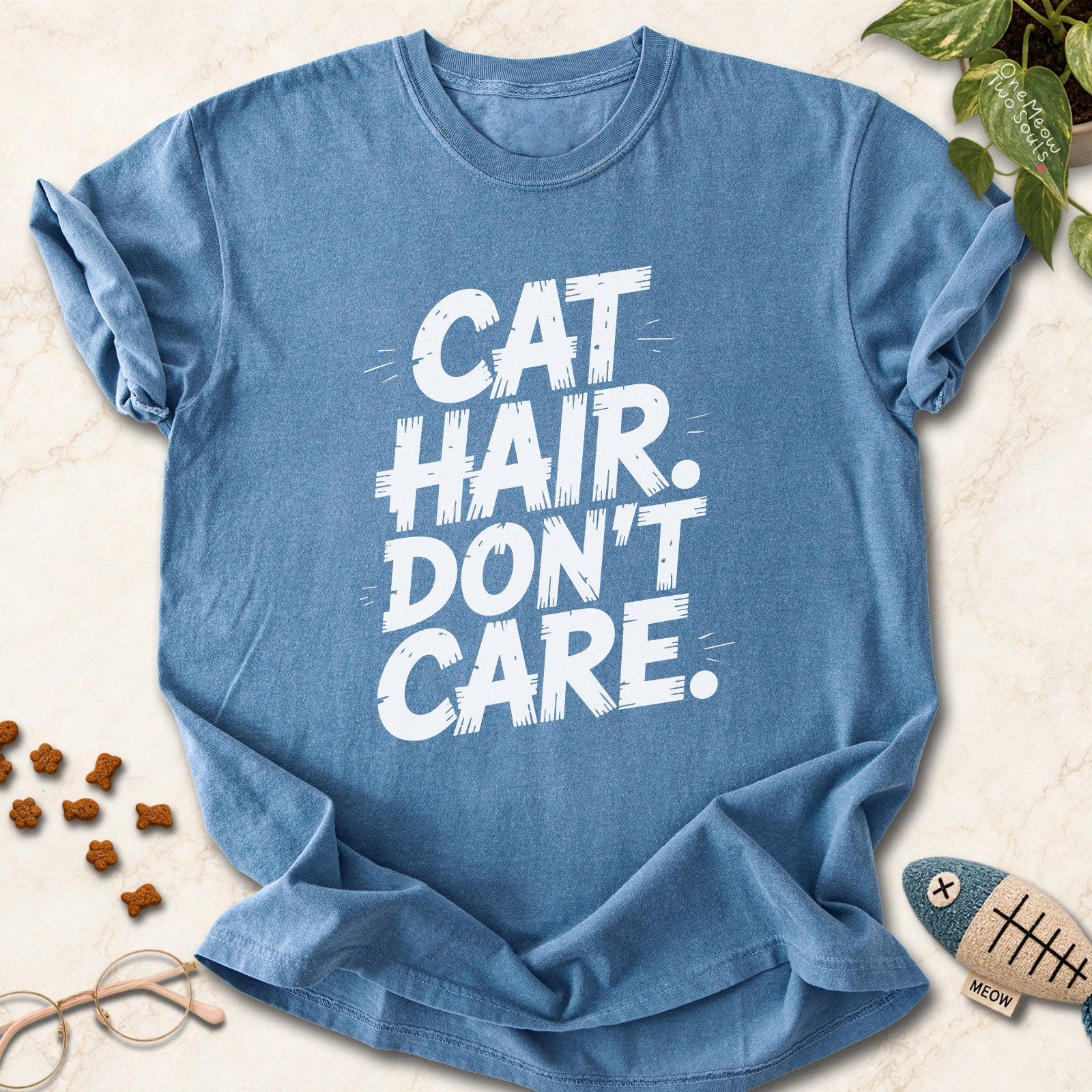 Blue Jean colored Comfort Colors 1717 cotton T-shirt, featuring a "Cat Hair Don't Care" funny cat design illustration. One Meow Two Souls brand.
