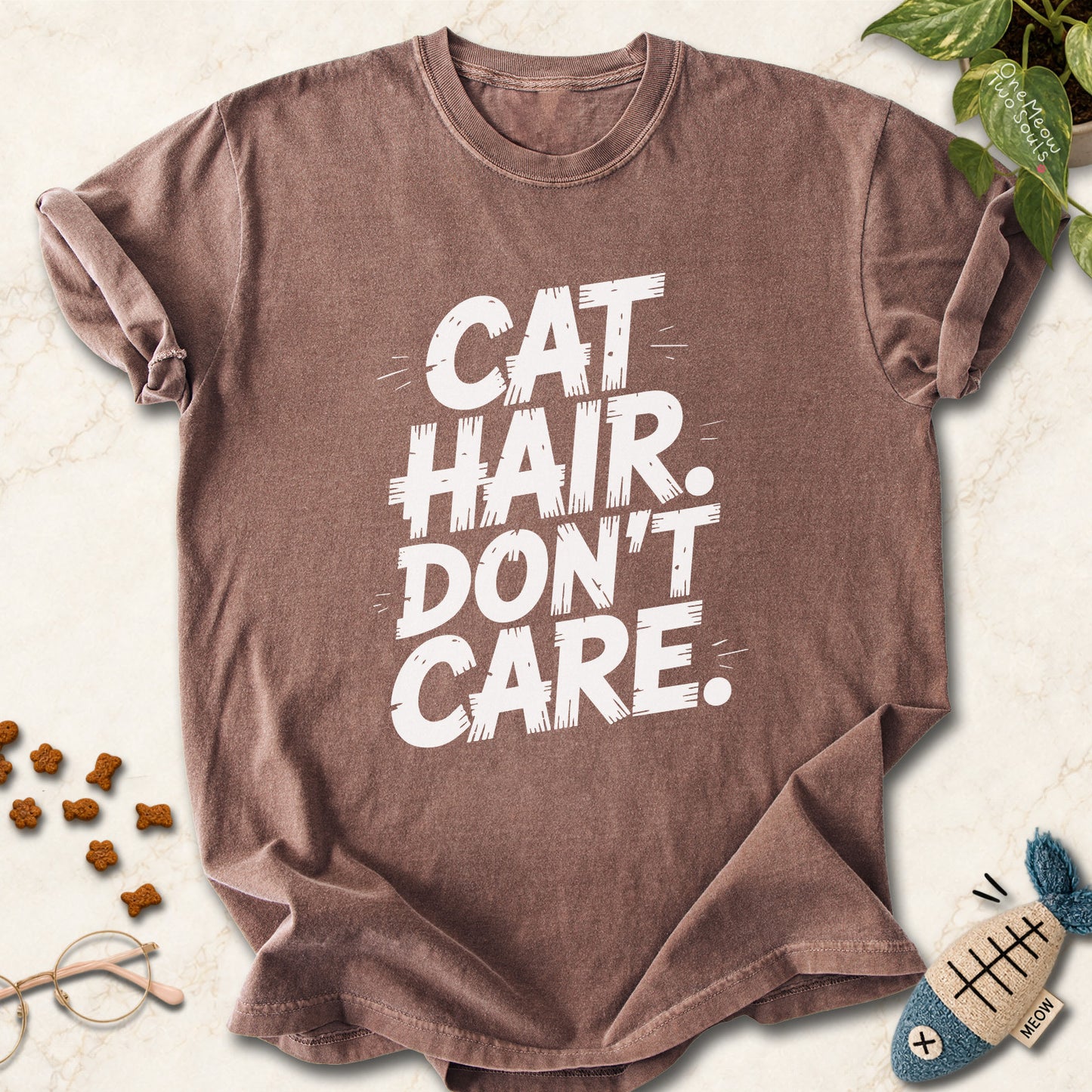 Espresso colored Comfort Colors 1717 cotton T-shirt, featuring a "Cat Hair Don't Care" funny cat design illustration. One Meow Two Souls brand.