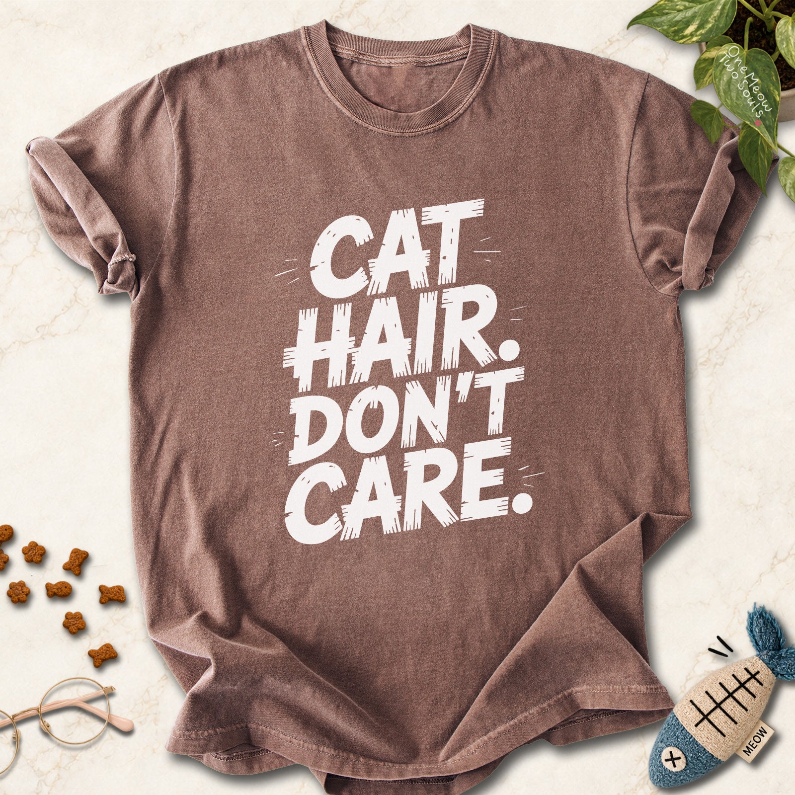 Espresso colored Comfort Colors 1717 cotton T-shirt, featuring a "Cat Hair Don't Care" funny cat design illustration. One Meow Two Souls brand.