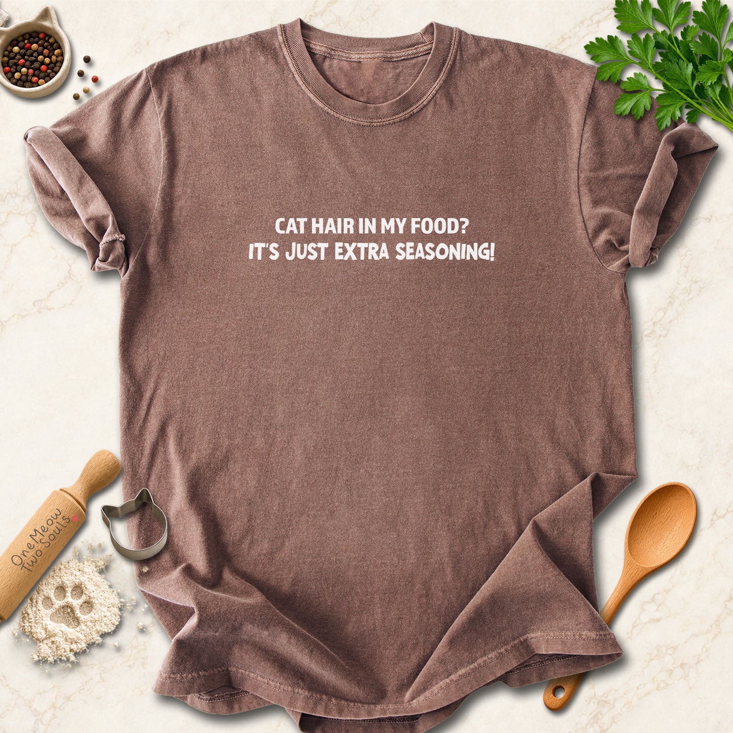 Espresso colored Comfort Colors 1717 cotton T-shirt, featuring a "Cat hair in my food? It's just extra seasoning" funny cat design illustration. One Meow Two Souls brand.