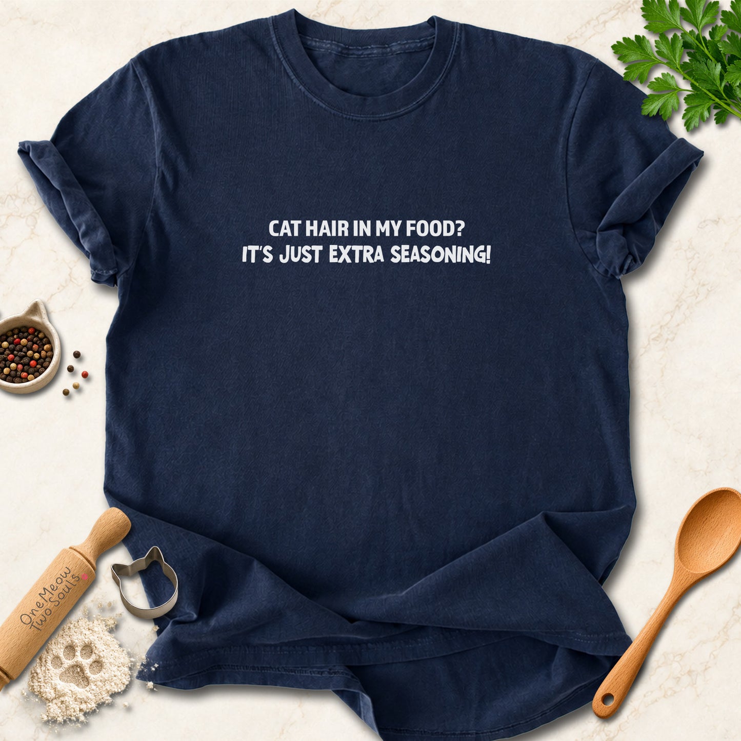 Navy colored Comfort Colors 1717 cotton T-shirt, featuring a "Cat hair in my food? It's just extra seasoning" funny cat design illustration. One Meow Two Souls brand.