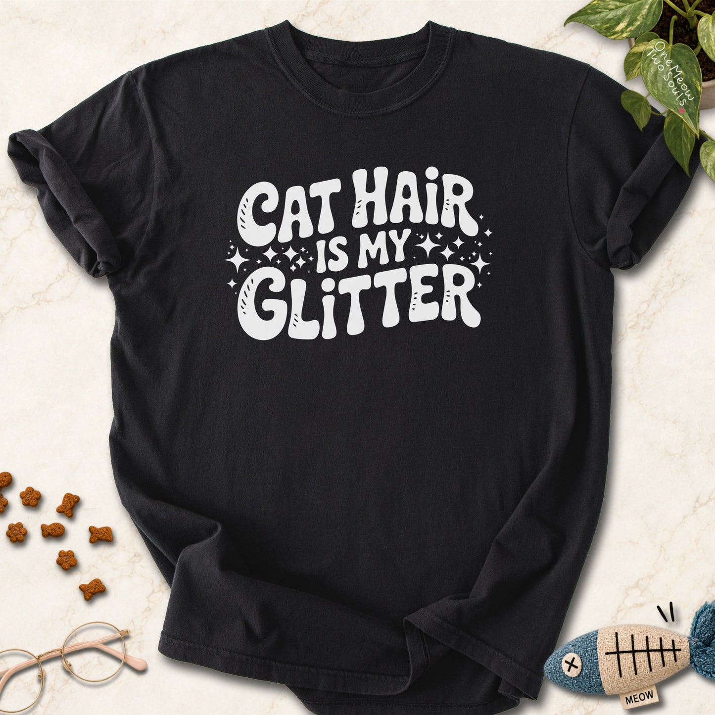 Black colored Comfort Colors 1717 cotton T-shirt, featuring a "Cat Hair Is My Glitter" funny cat design illustration. One Meow Two Souls brand.