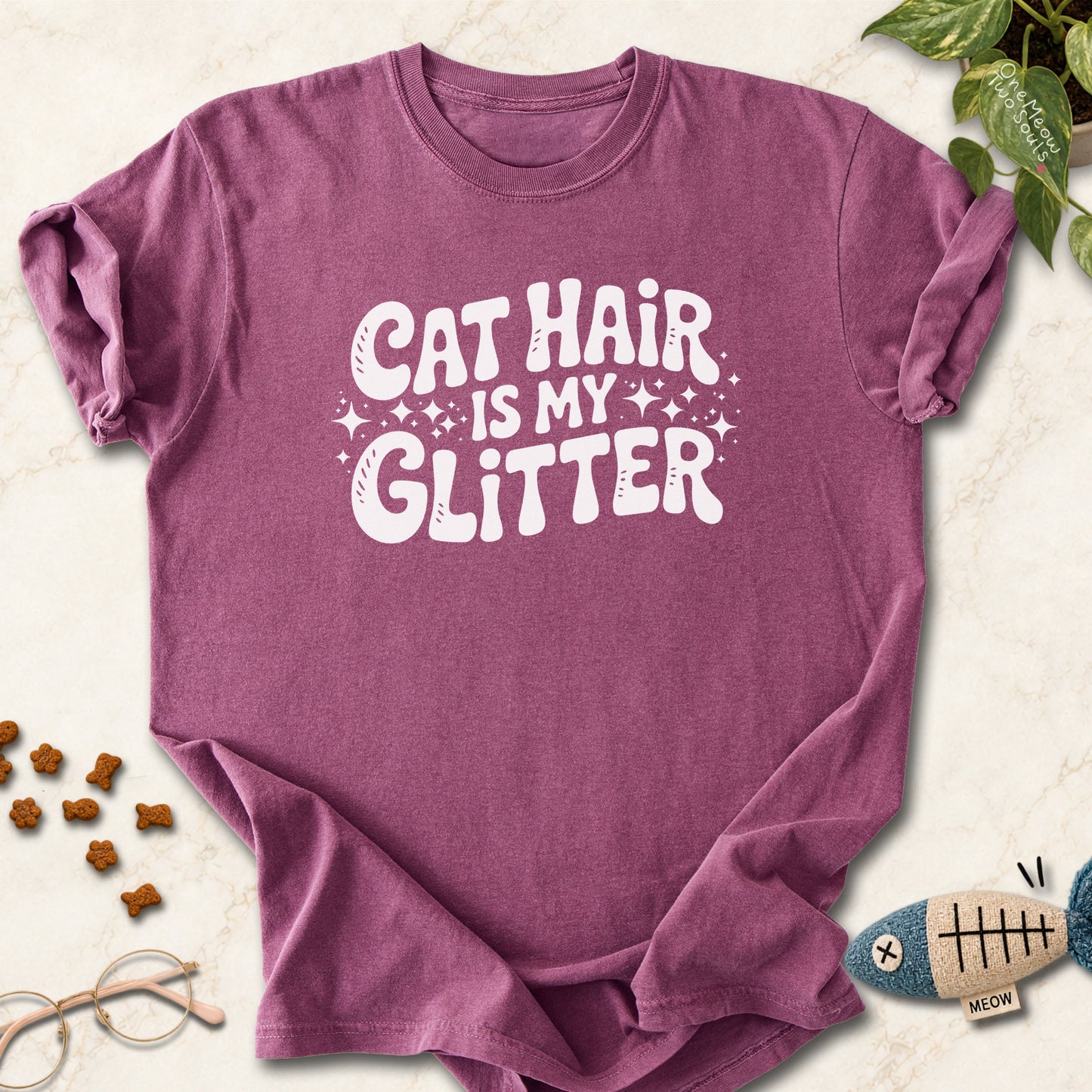 Berry colored Comfort Colors 1717 cotton T-shirt, featuring a "Cat Hair Is My Glitter" funny cat design illustration. One Meow Two Souls brand.