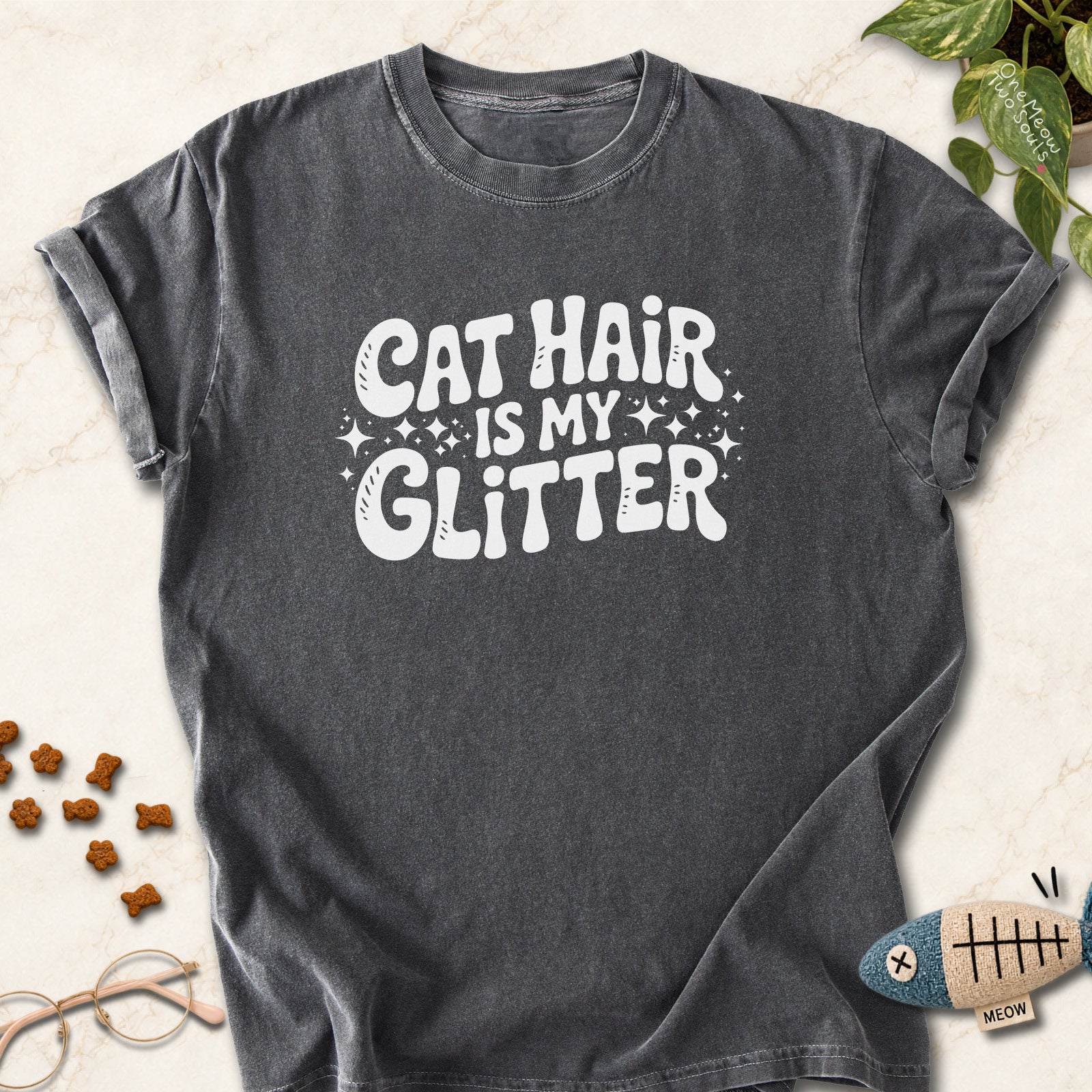 Pepper colored Comfort Colors 1717 cotton T-shirt, featuring a "Cat Hair Is My Glitter" funny cat design illustration. One Meow Two Souls brand.