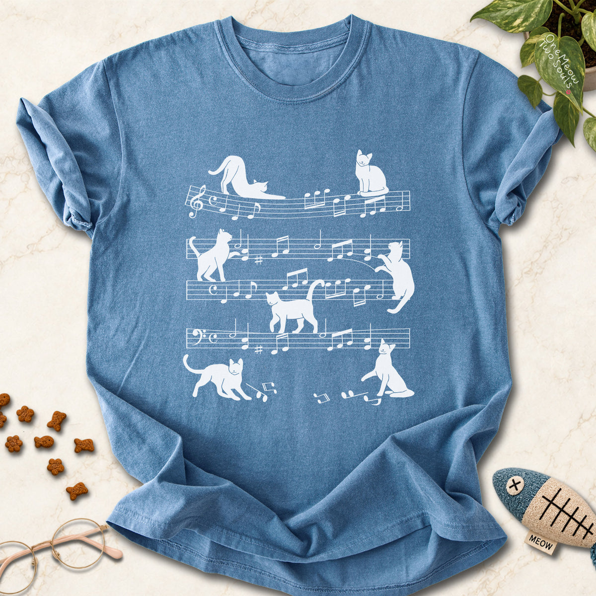 Blue Jean colored Comfort Colors 1717 cotton T-shirt, featuring a Cat music sheet funny cat design illustration. One Meow Two Souls brand.