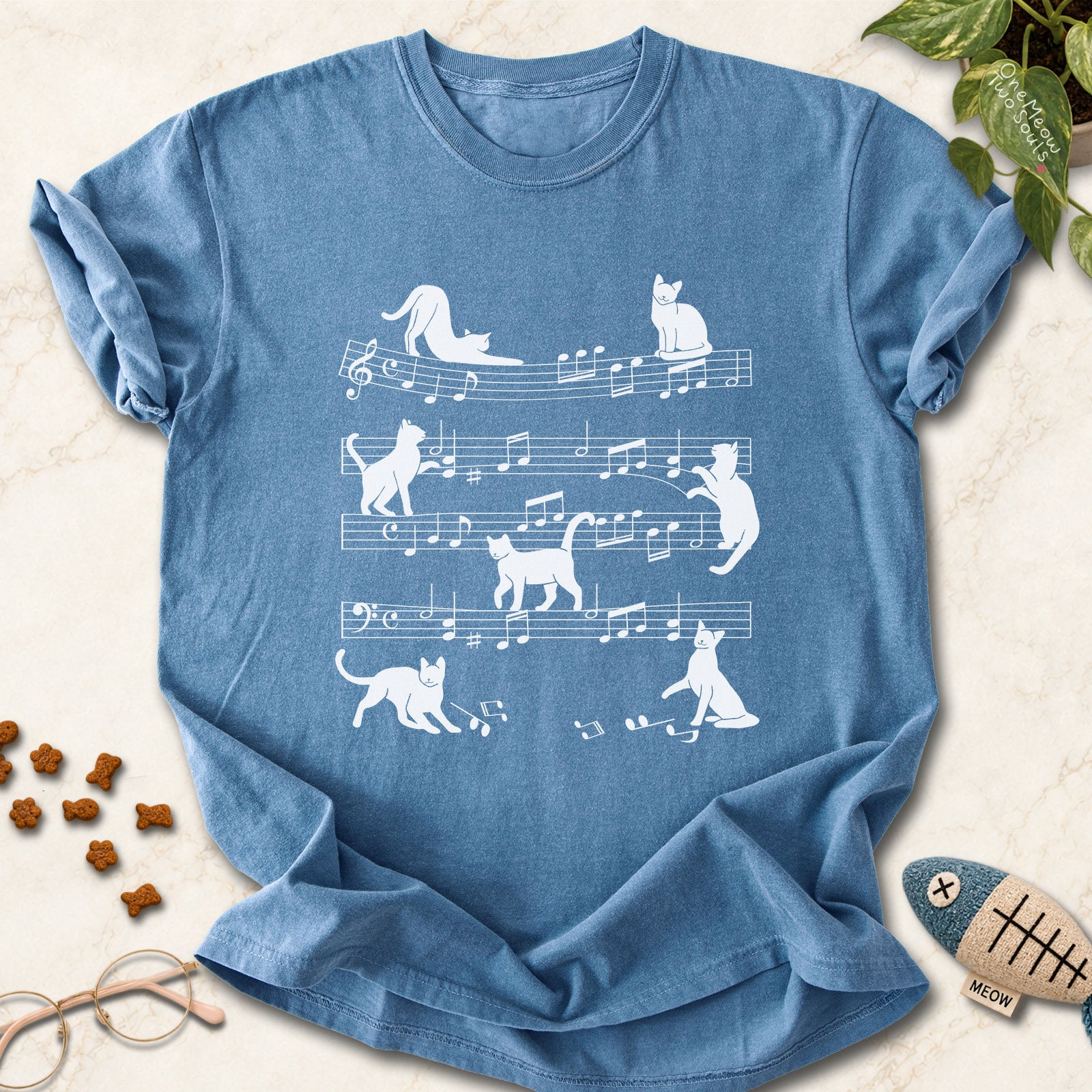 Blue Jean colored Comfort Colors 1717 cotton T-shirt, featuring a Cat music sheet funny cat design illustration. One Meow Two Souls brand.