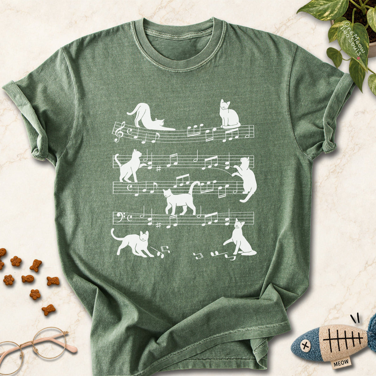 Moss colored Comfort Colors 1717 cotton T-shirt, featuring a Cat music sheet funny cat design illustration. One Meow Two Souls brand.
