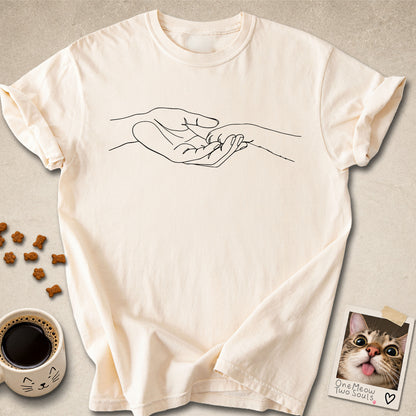Ivory colored Comfort Colors 1717 cotton T-shirt, featuring a cute cat paw and human hand design illustration. One Meow Two Souls brand.
