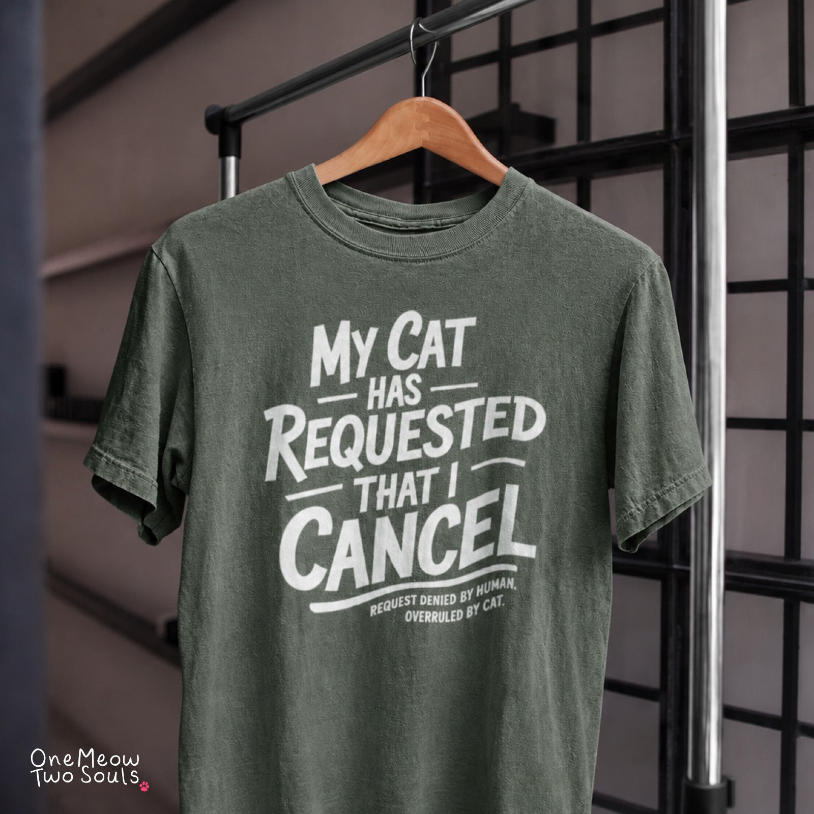 Moss colored Comfort Colors 1717 cotton T-shirt, featuring a "My Cat Has Requested That I Cancel" funny cat design illustration. One Meow Two Souls brand.