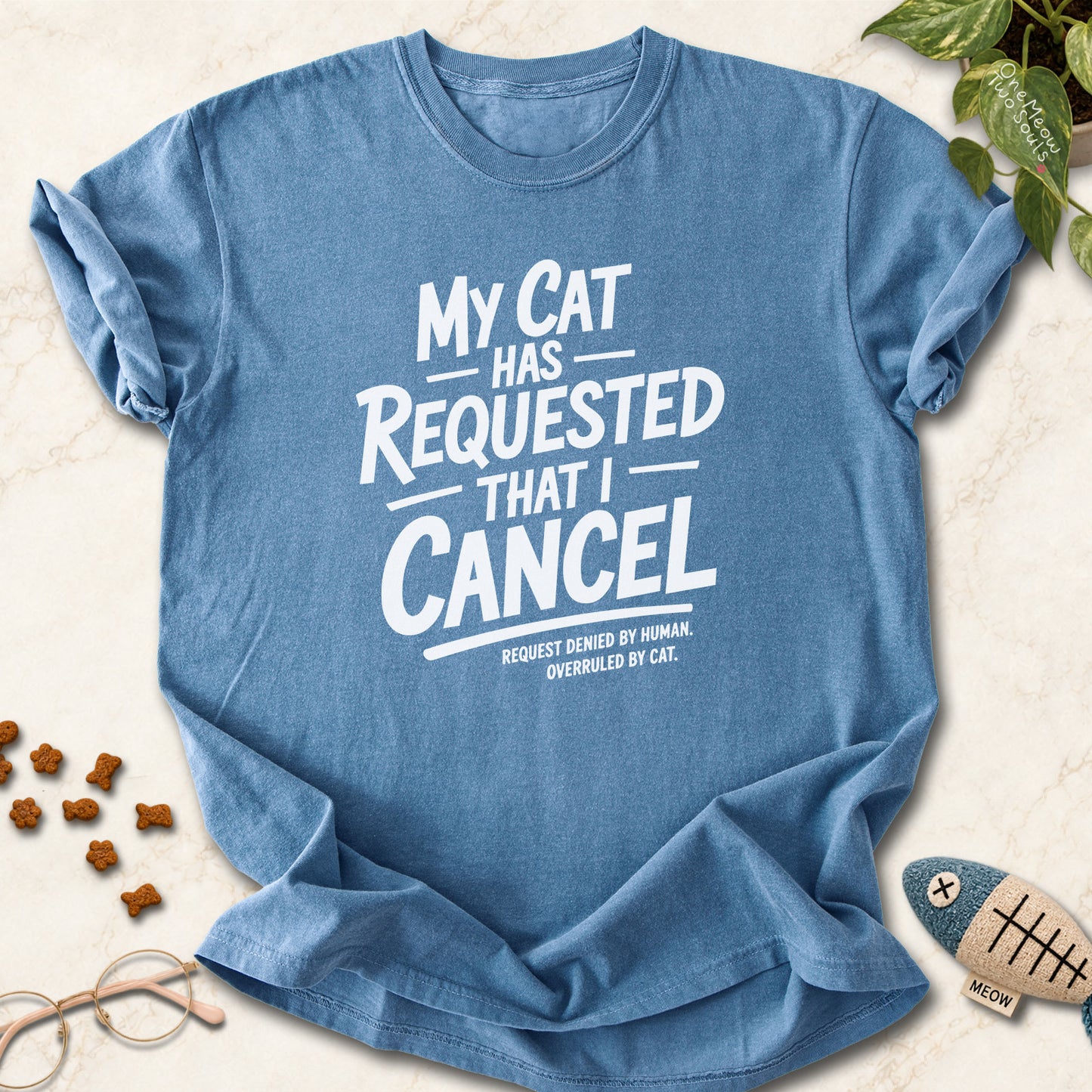 Blue Jean colored Comfort Colors 1717 cotton T-shirt, featuring a "My Cat Has Requested That I Cancel" funny cat design illustration. One Meow Two Souls brand.