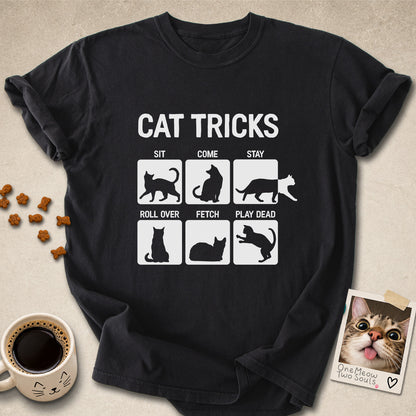 Black colored Comfort Colors 1717 cotton T-shirt, featuring a "Cat Tricks" funny cat design illustration. One Meow Two Souls brand.