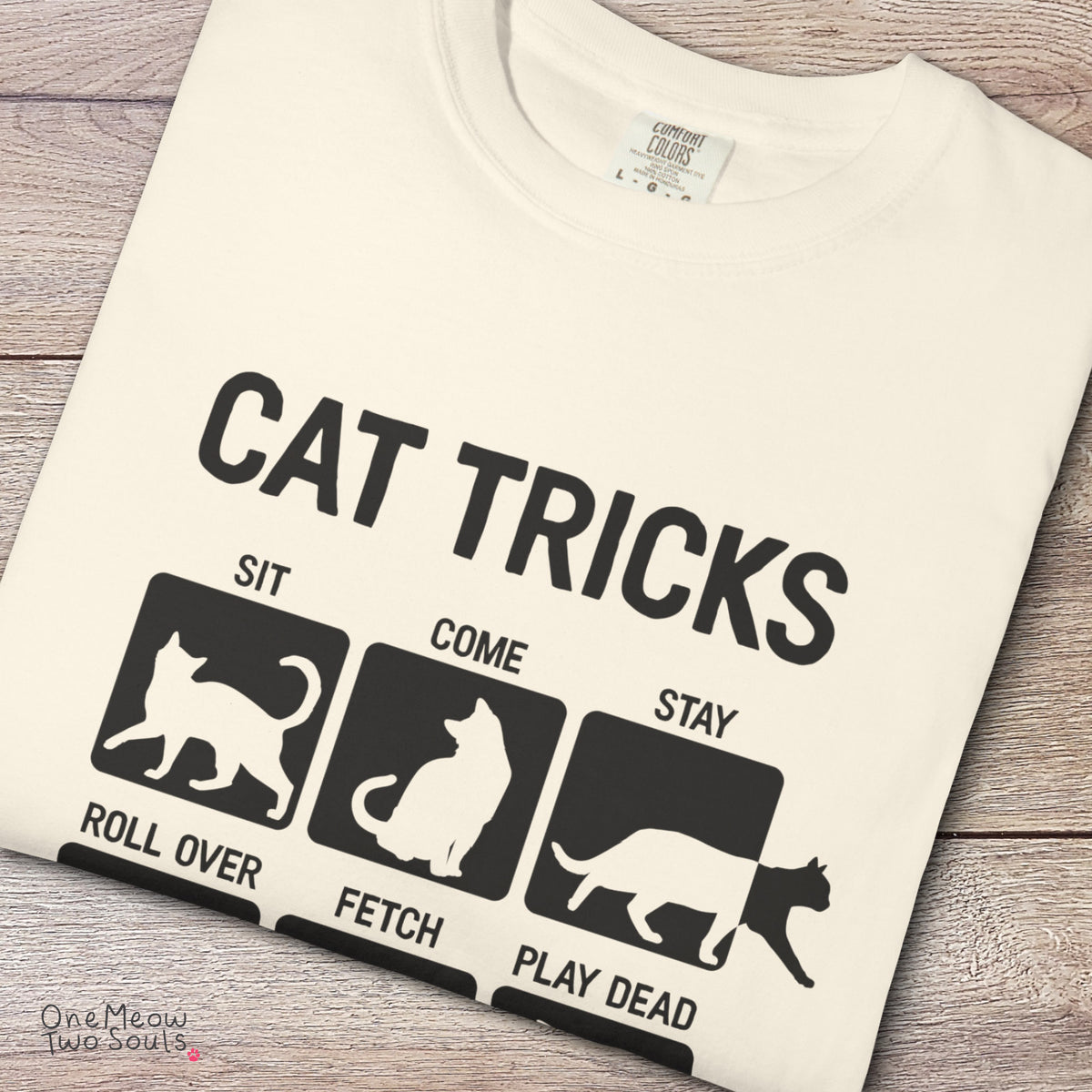 Ivory colored Comfort Colors 1717 cotton T-shirt, featuring a "Cat Tricks" funny cat design illustration. One Meow Two Souls brand.
