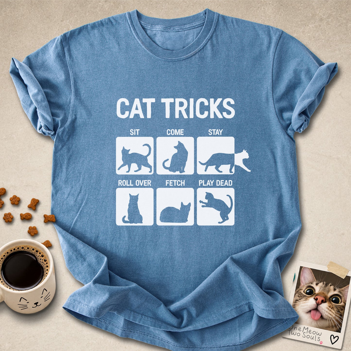 Blue jean colored Comfort Colors 1717 cotton T-shirt, featuring a "Cat Tricks" funny cat design illustration. One Meow Two Souls brand.
